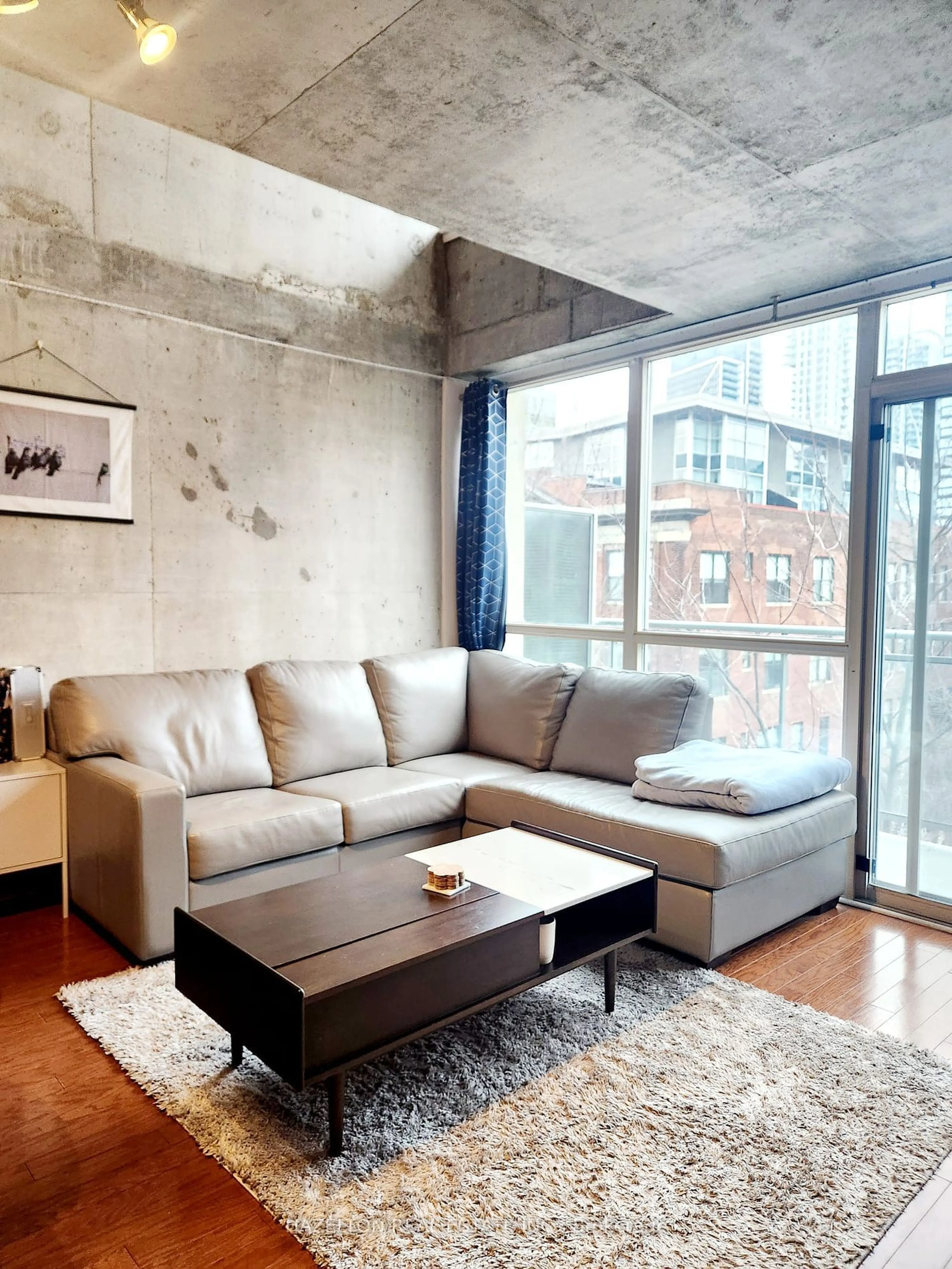 Living room with furniture, cement floor for 954 King St #508, Toronto Ontario M6K 3L9