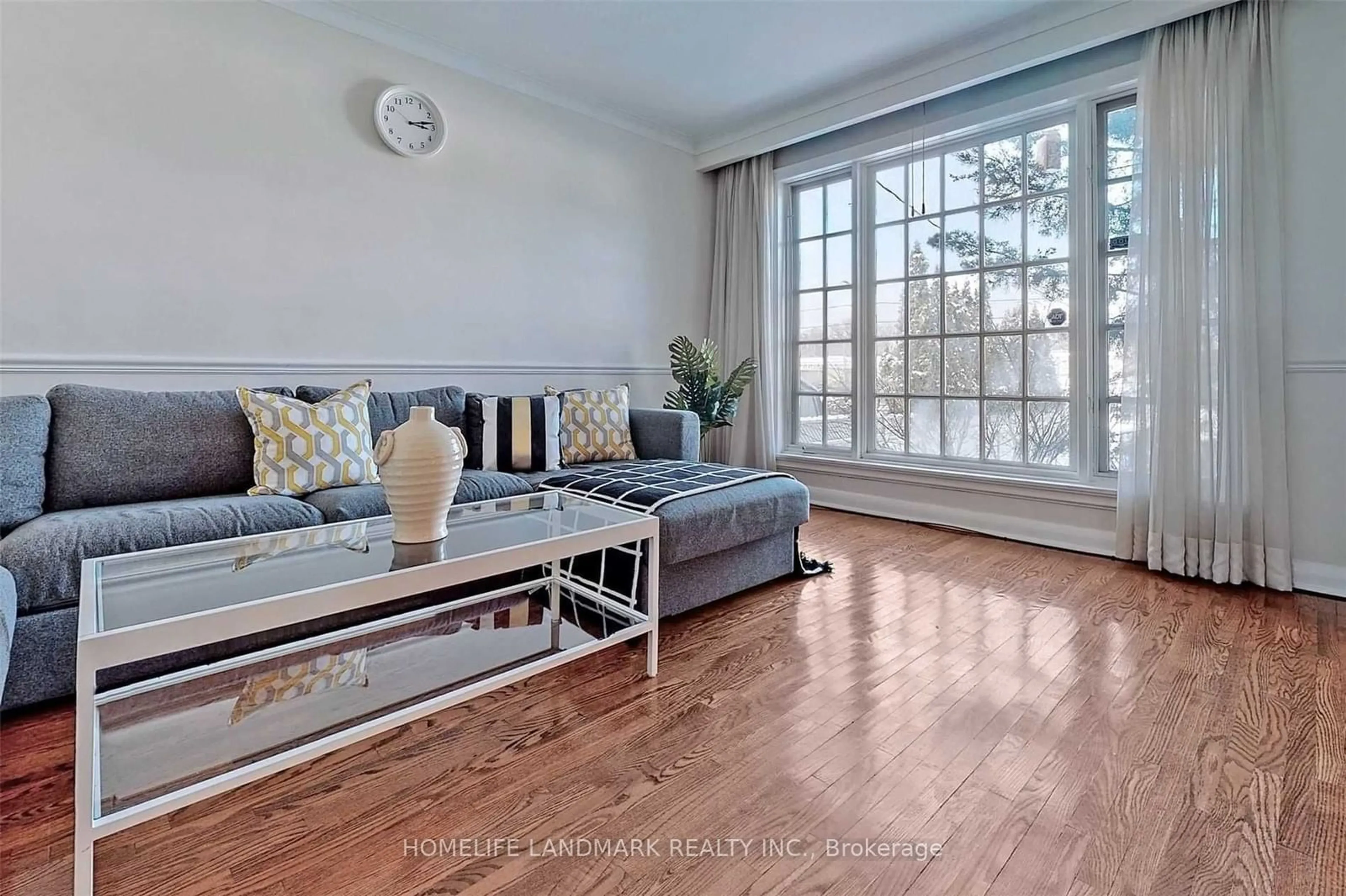 Living room with furniture, wood/laminate floor for 177 Delhi Ave, Toronto Ontario M3H 1A7