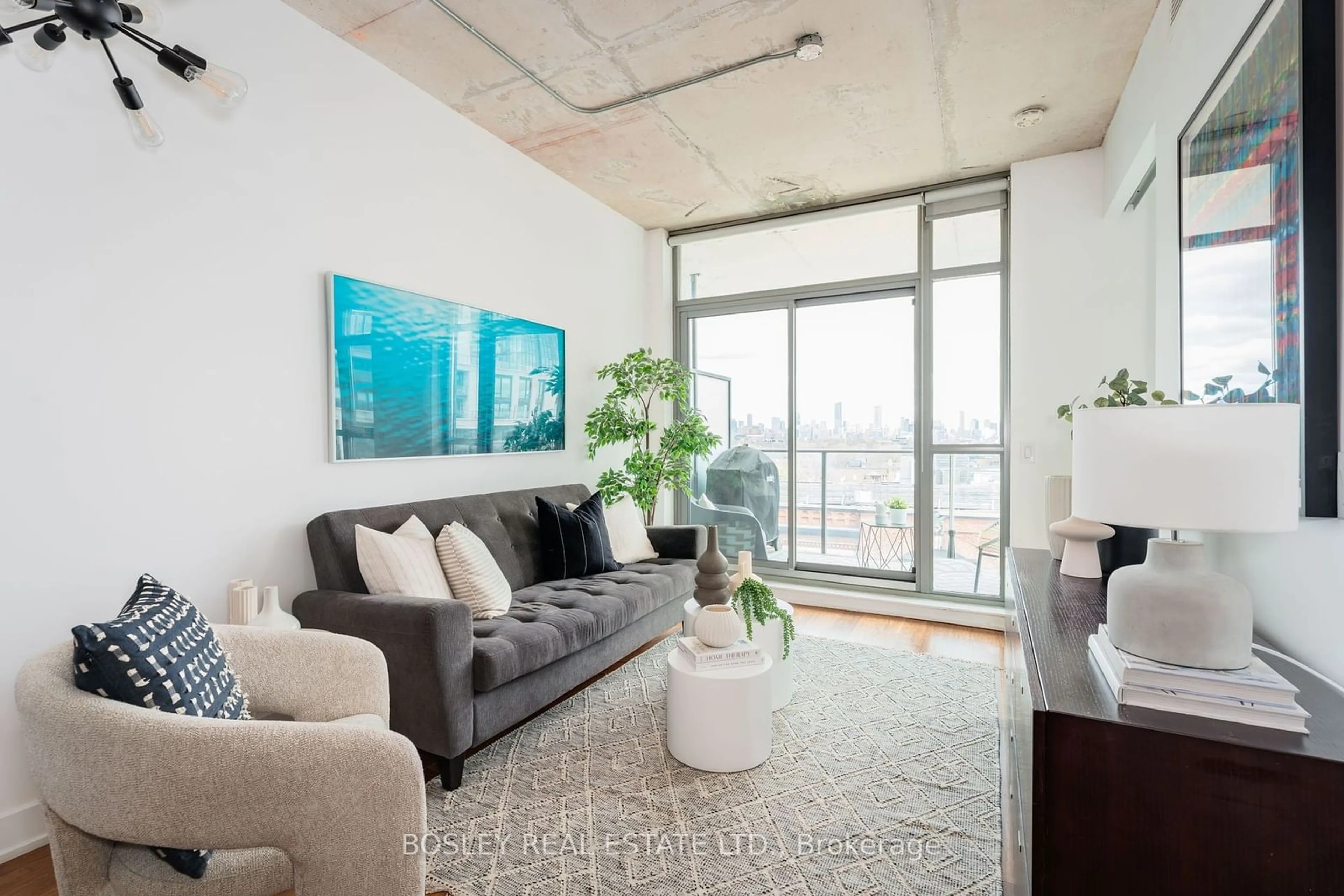 Living room with furniture, cement floor for 2 Gladstone Ave #704, Toronto Ontario M6J 0B2