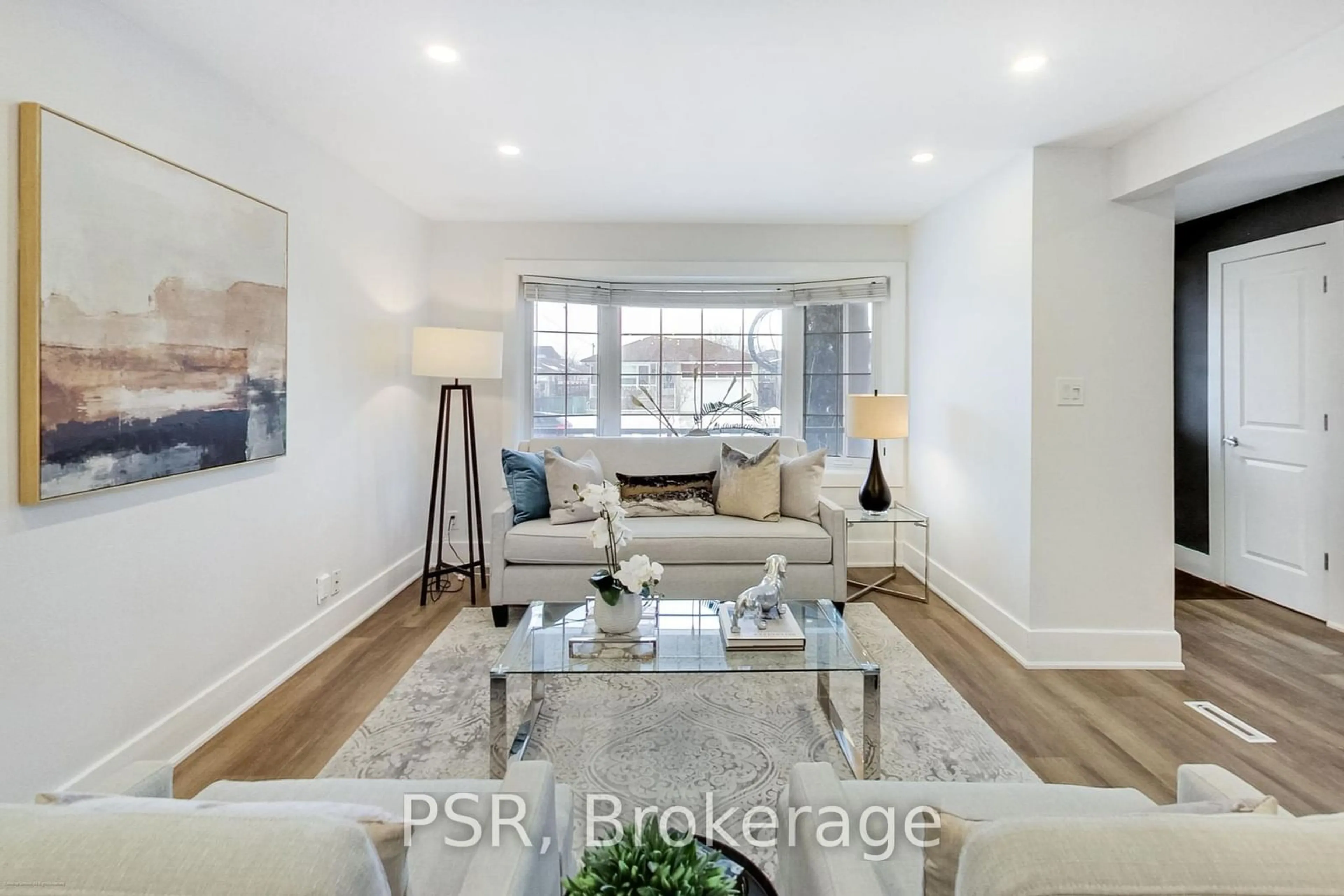 Living room with furniture, wood/laminate floor for 201 Ranee Ave, Toronto Ontario M6A 1N3