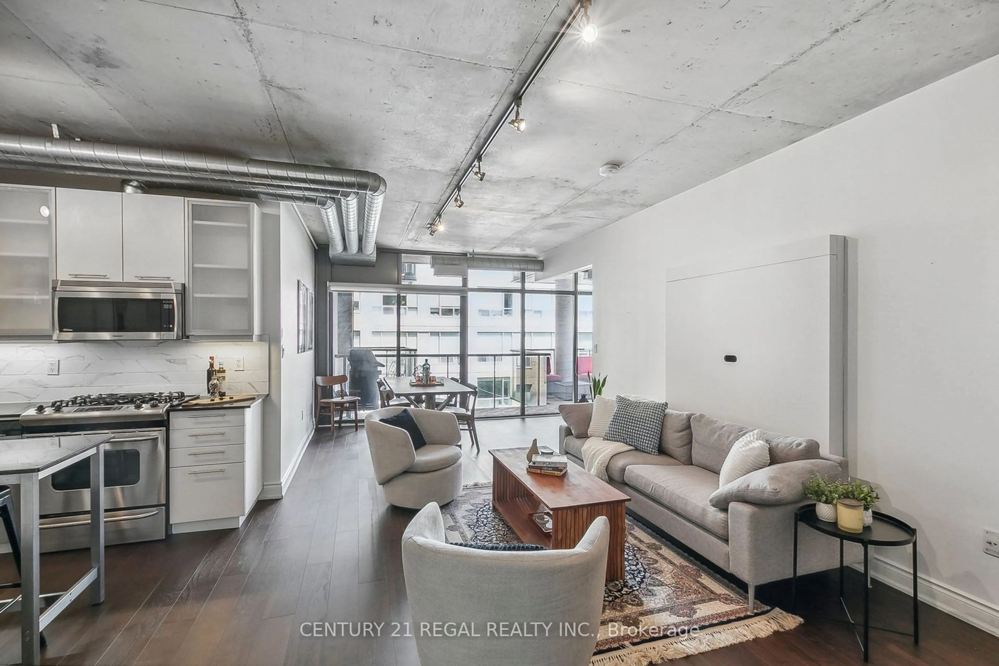 Living room with furniture, cement floor for 533 Richmond St #605, Toronto Ontario M5V 3Y1