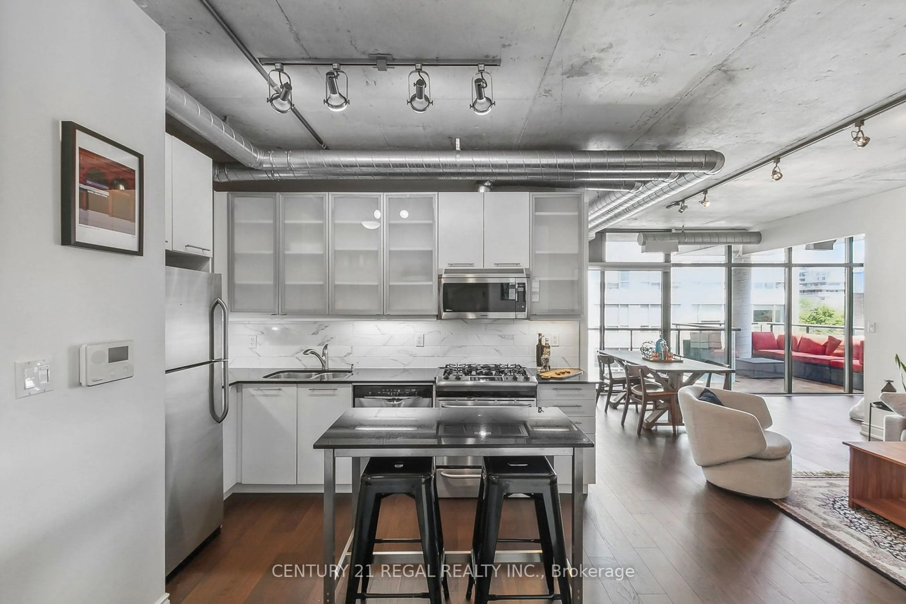 Open concept kitchen, cement floor for 533 Richmond St #605, Toronto Ontario M5V 3Y1