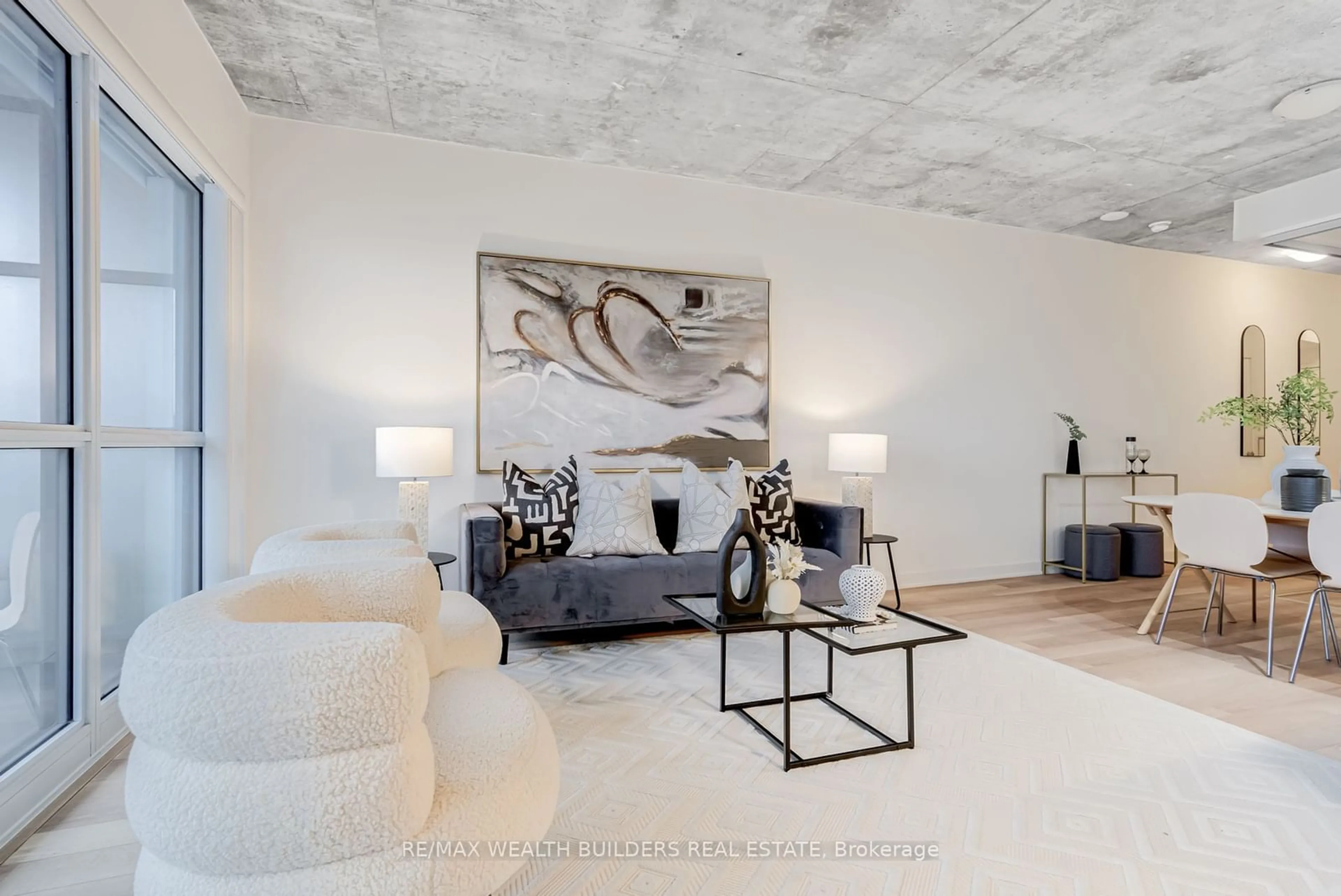 Living room with furniture, cement floor for 210 Simcoe St #1706, Toronto Ontario M5T 1T4