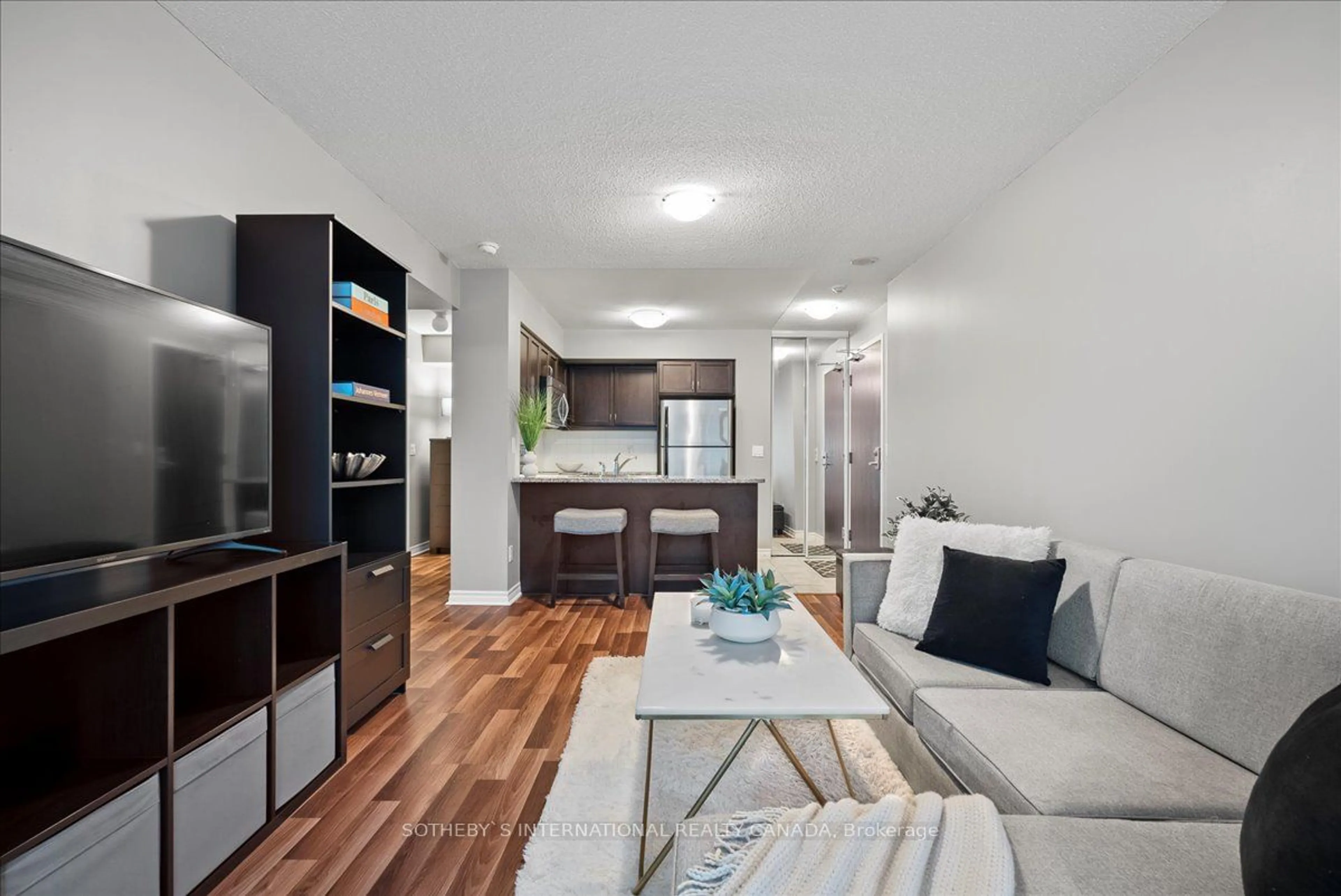 Living room with furniture, wood/laminate floor for 19 Grand Trunk Cres #707, Toronto Ontario M5J 3A3