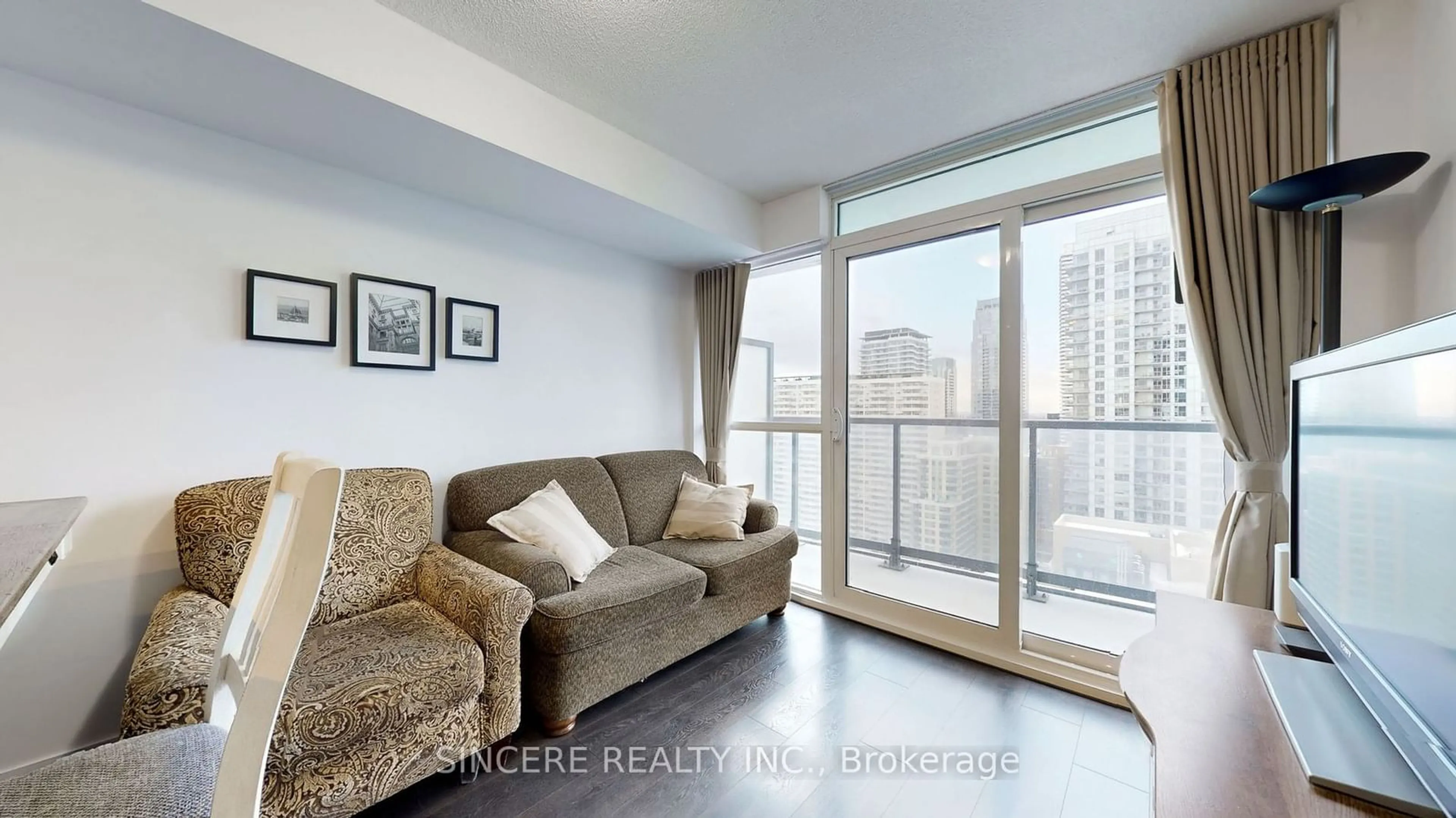 Living room with furniture, wood/laminate floor for 125 Redpath Ave #2507, Toronto Ontario M4S 0B5