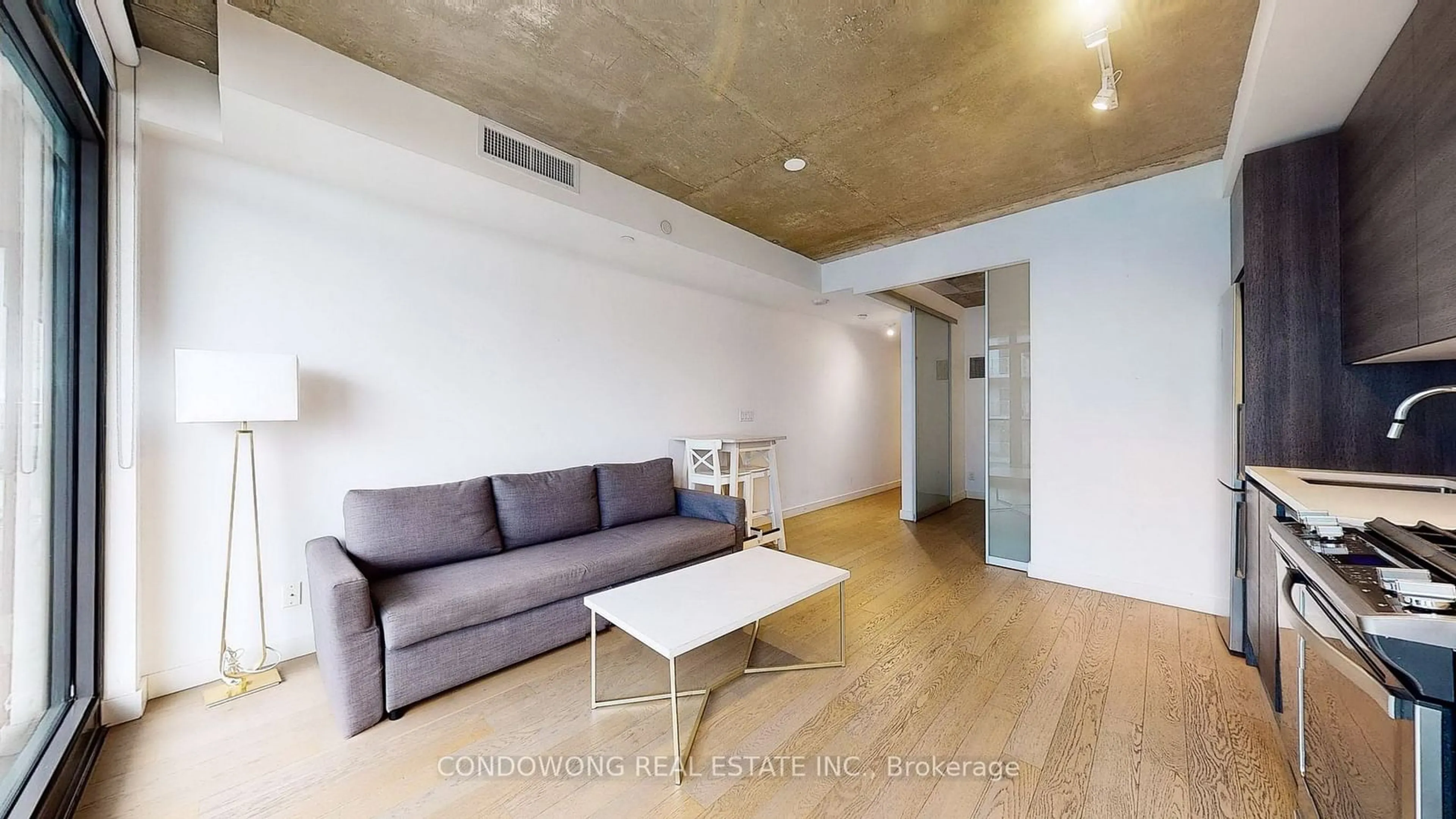 Living room with furniture, wood/laminate floor for 111 Bathurst St #1410, Toronto Ontario M5V 0M9