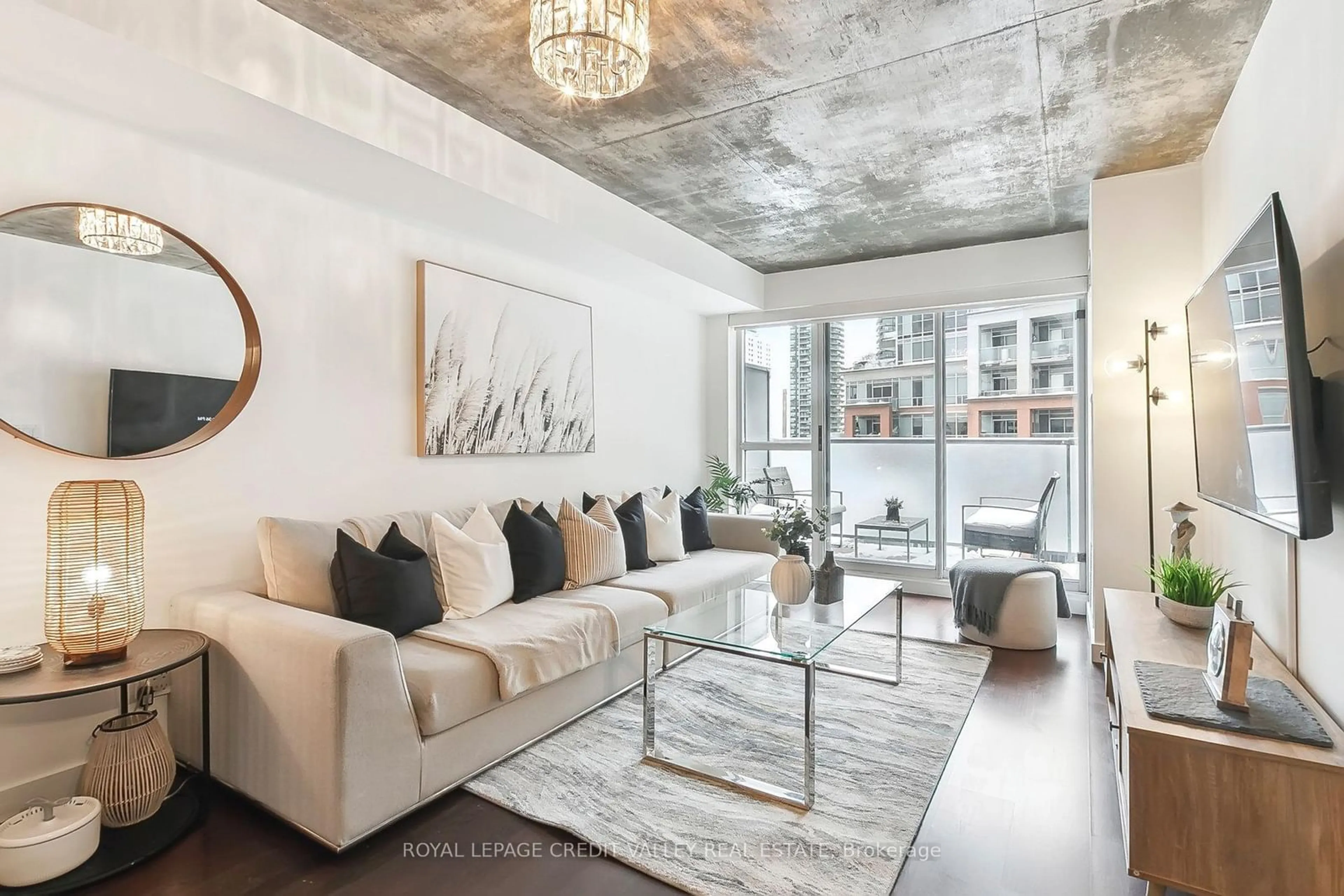 Living room with furniture, cement floor for 1005 King St #625, Toronto Ontario M6K 3M8