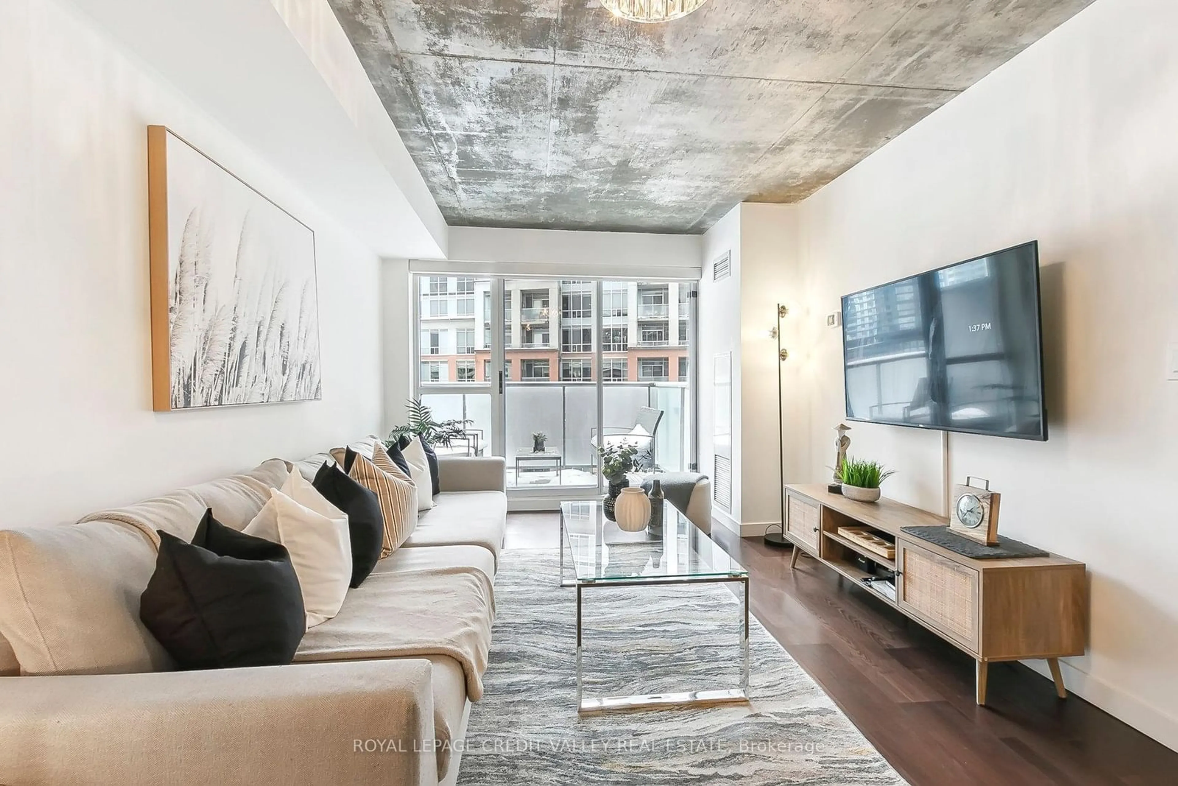 Living room with furniture, cement floor for 1005 King St #625, Toronto Ontario M6K 3M8