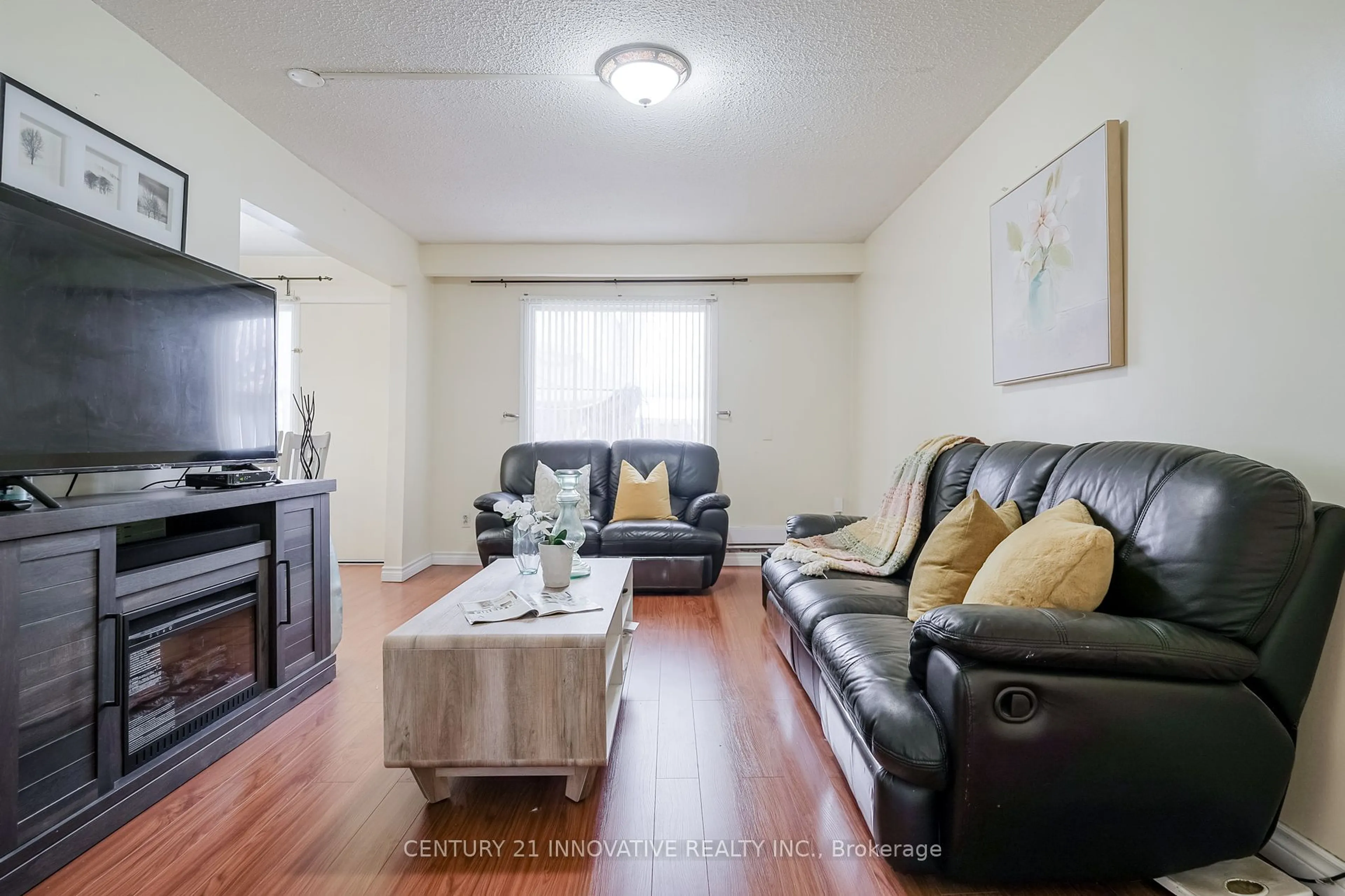 Living room with furniture, wood/laminate floor for 42 Elsa Vine Way #143, Toronto Ontario M2J 4H9