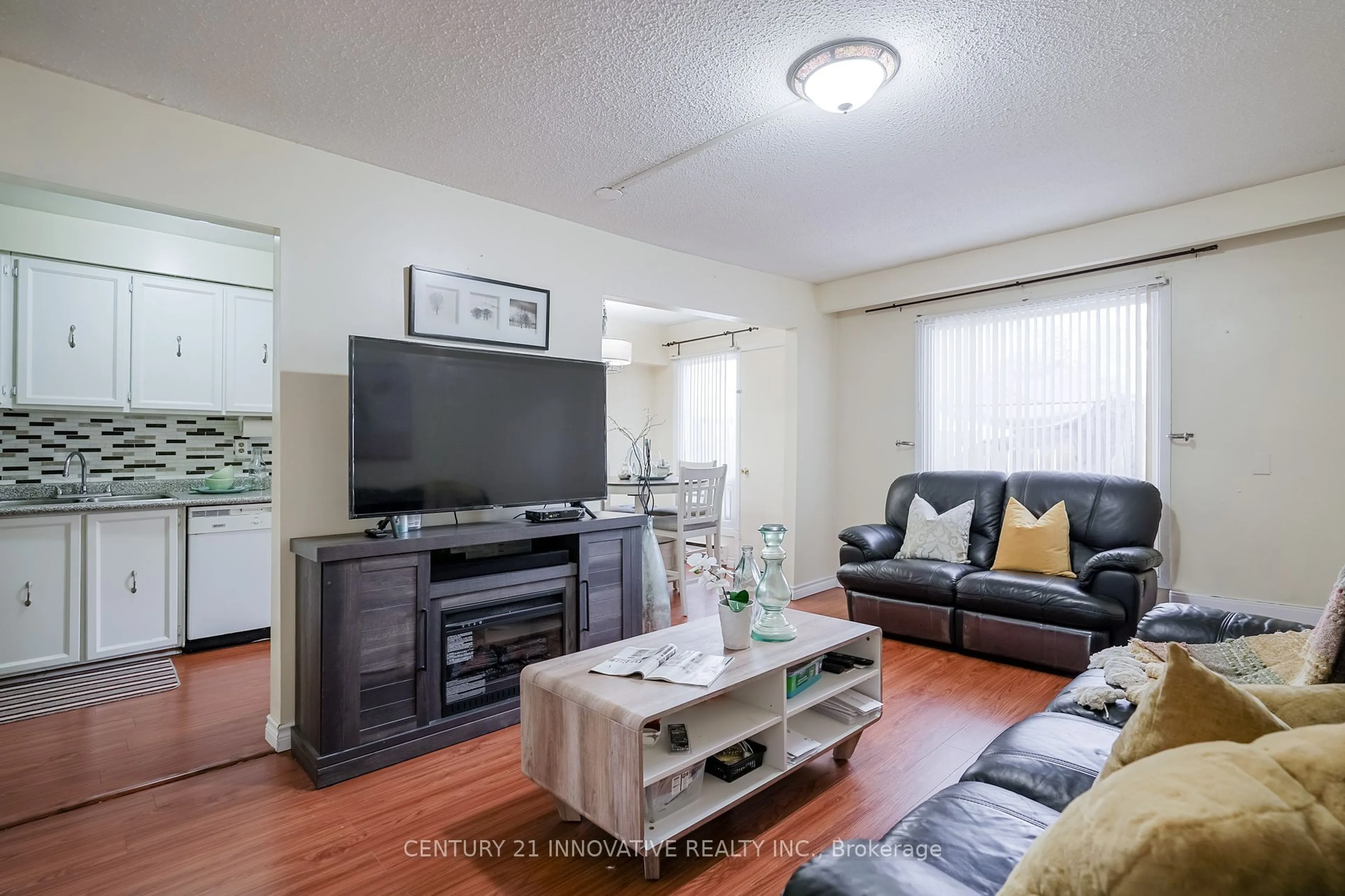 Living room with furniture, wood/laminate floor for 42 Elsa Vine Way #143, Toronto Ontario M2J 4H9