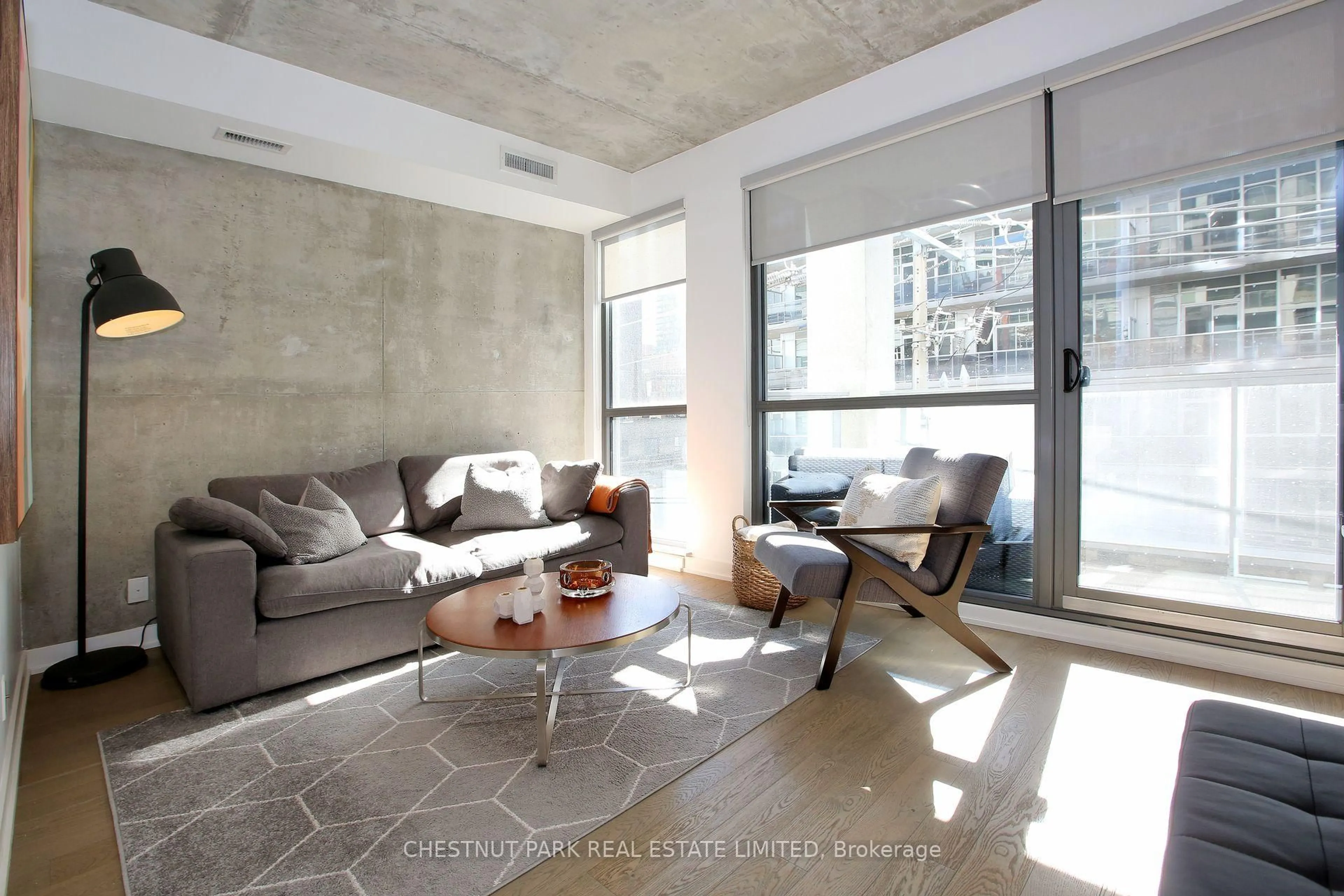 Living room with furniture, cement floor for 39 Brant St #310, Toronto Ontario M5V 2L9