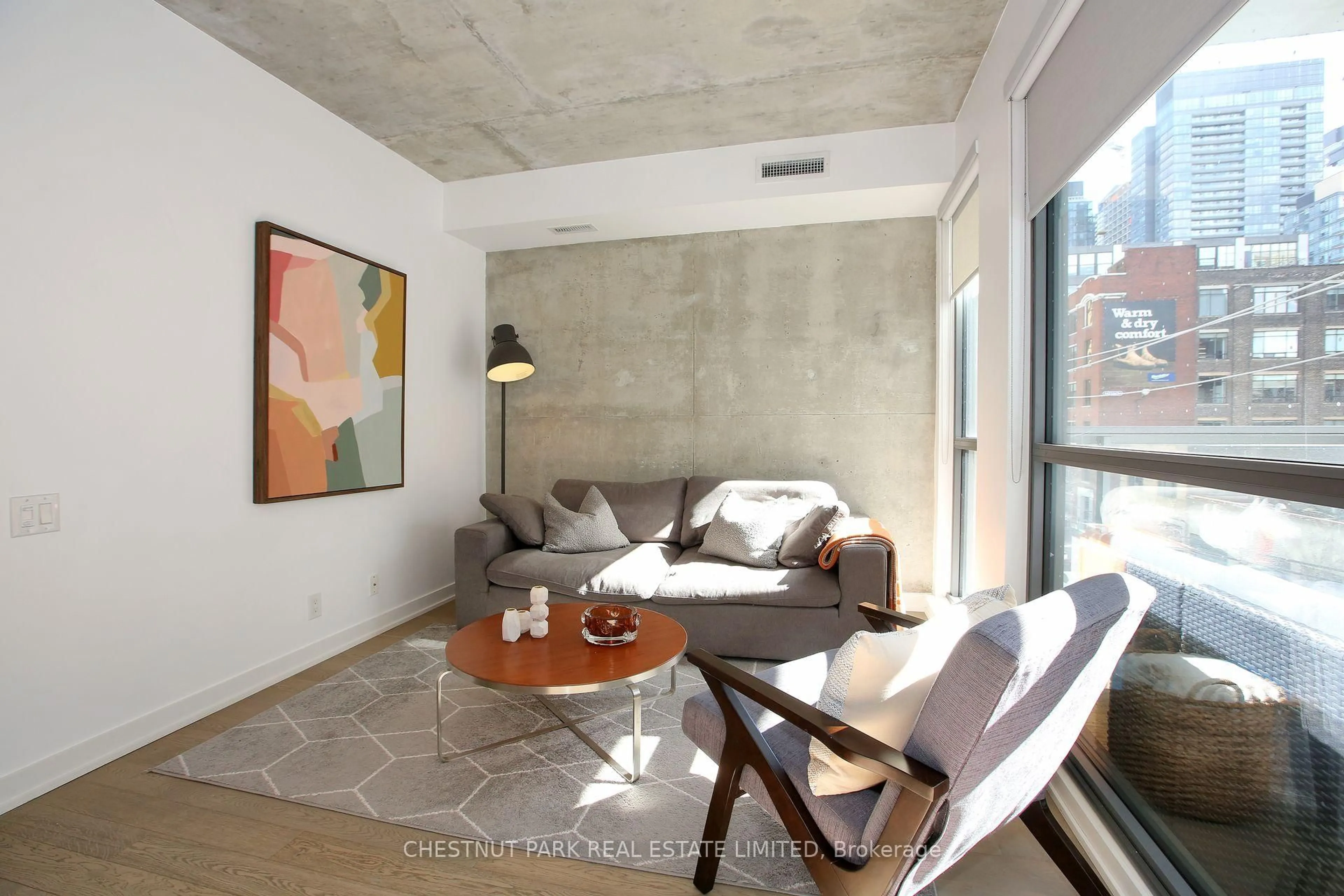 Living room with furniture, cement floor for 39 Brant St #310, Toronto Ontario M5V 2L9