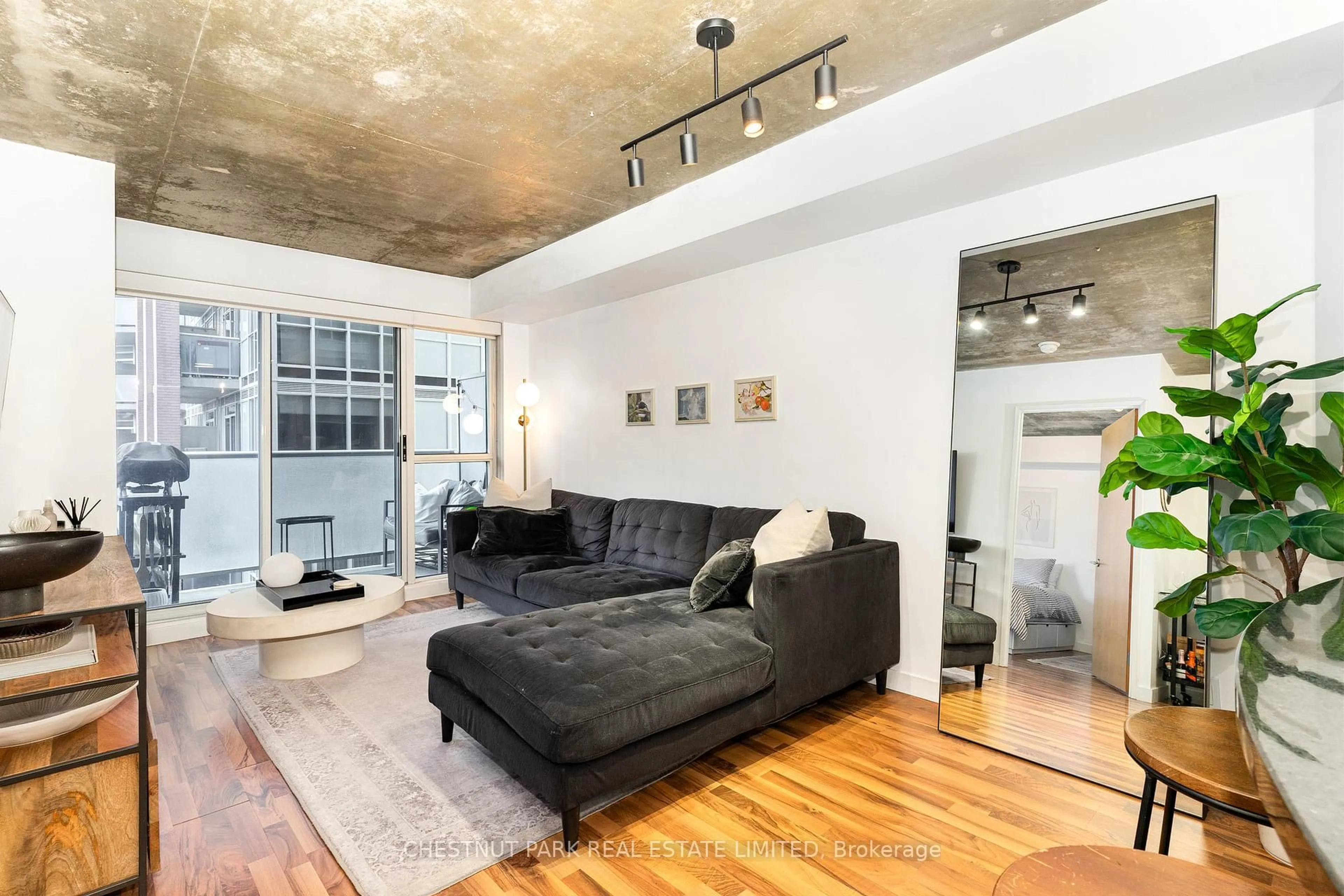 Living room with furniture, cement floor for 1005 King St #404, Toronto Ontario M6K 3M8