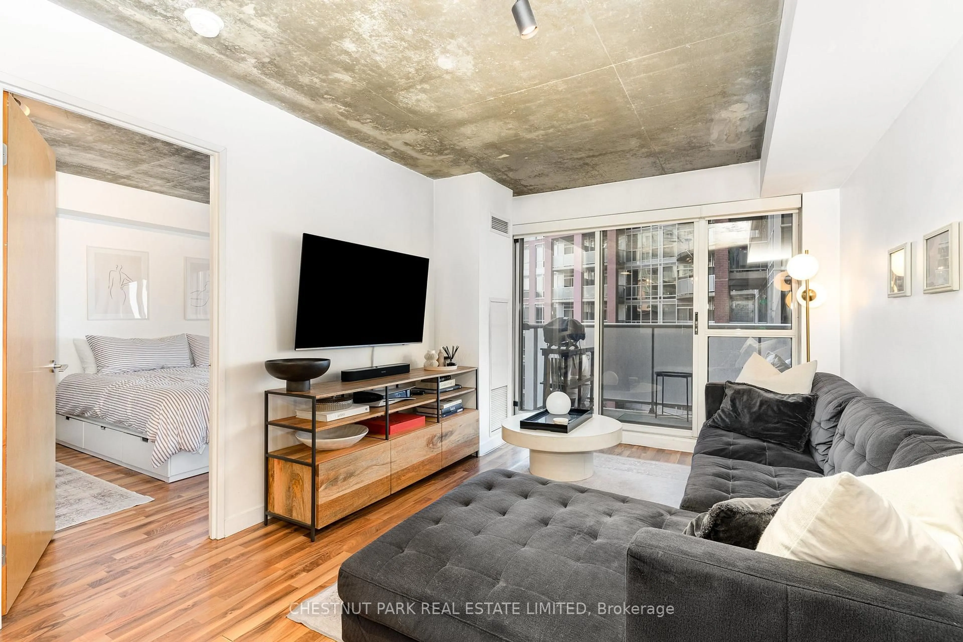 Living room with furniture, cement floor for 1005 King St #404, Toronto Ontario M6K 3M8