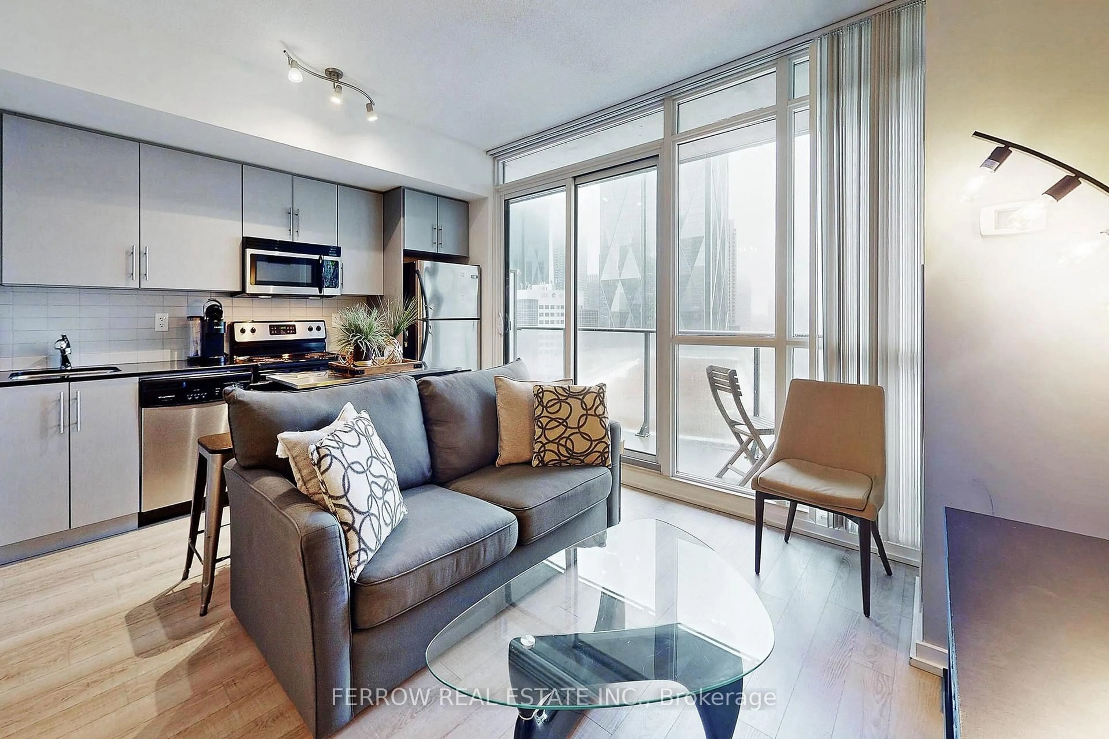 Living room with furniture, wood/laminate floor for 55 Bremner Blvd #1306, Toronto Ontario M5J 0A6