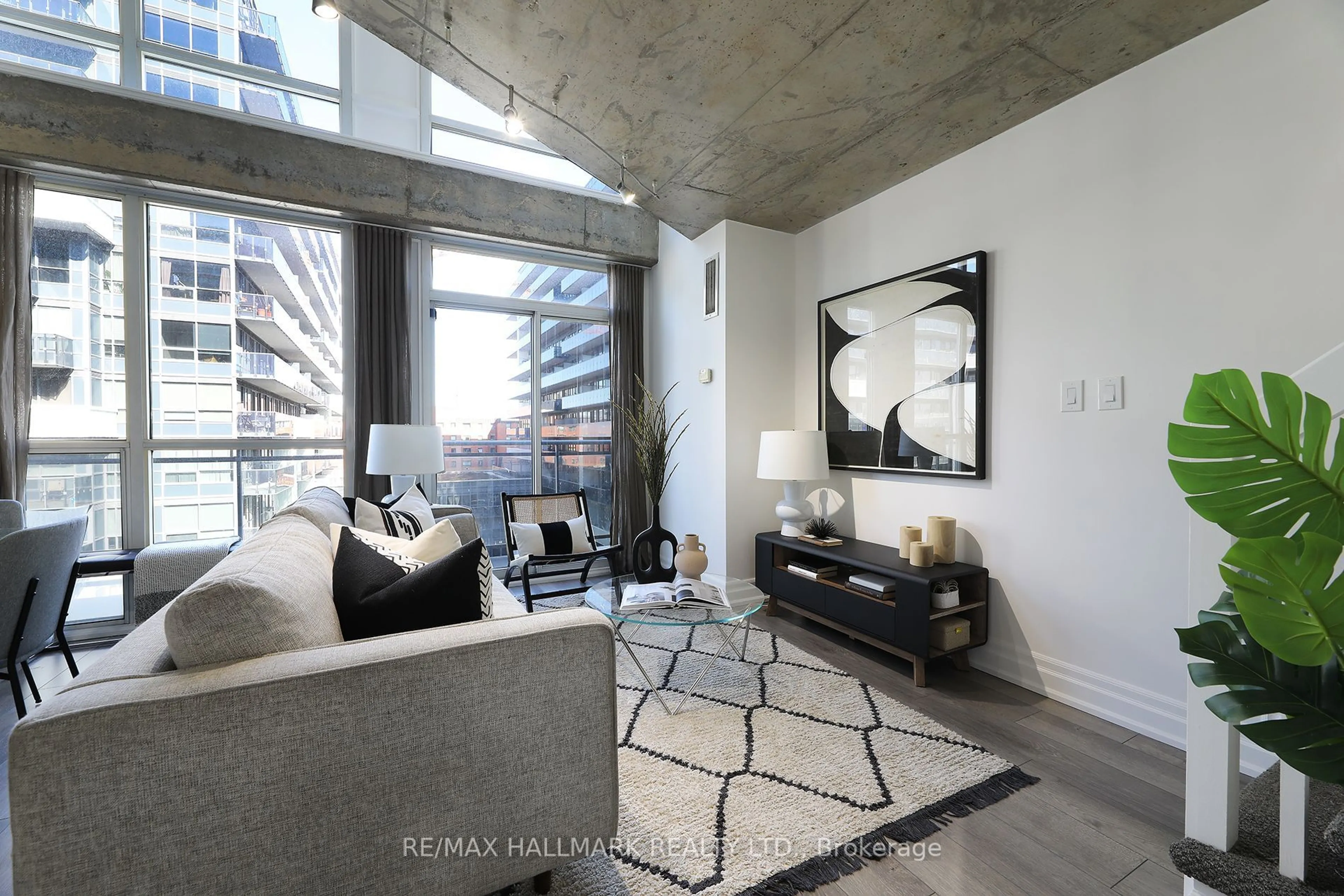 Living room with furniture, cement floor for 1029 King St #818, Toronto Ontario M6K 3M9