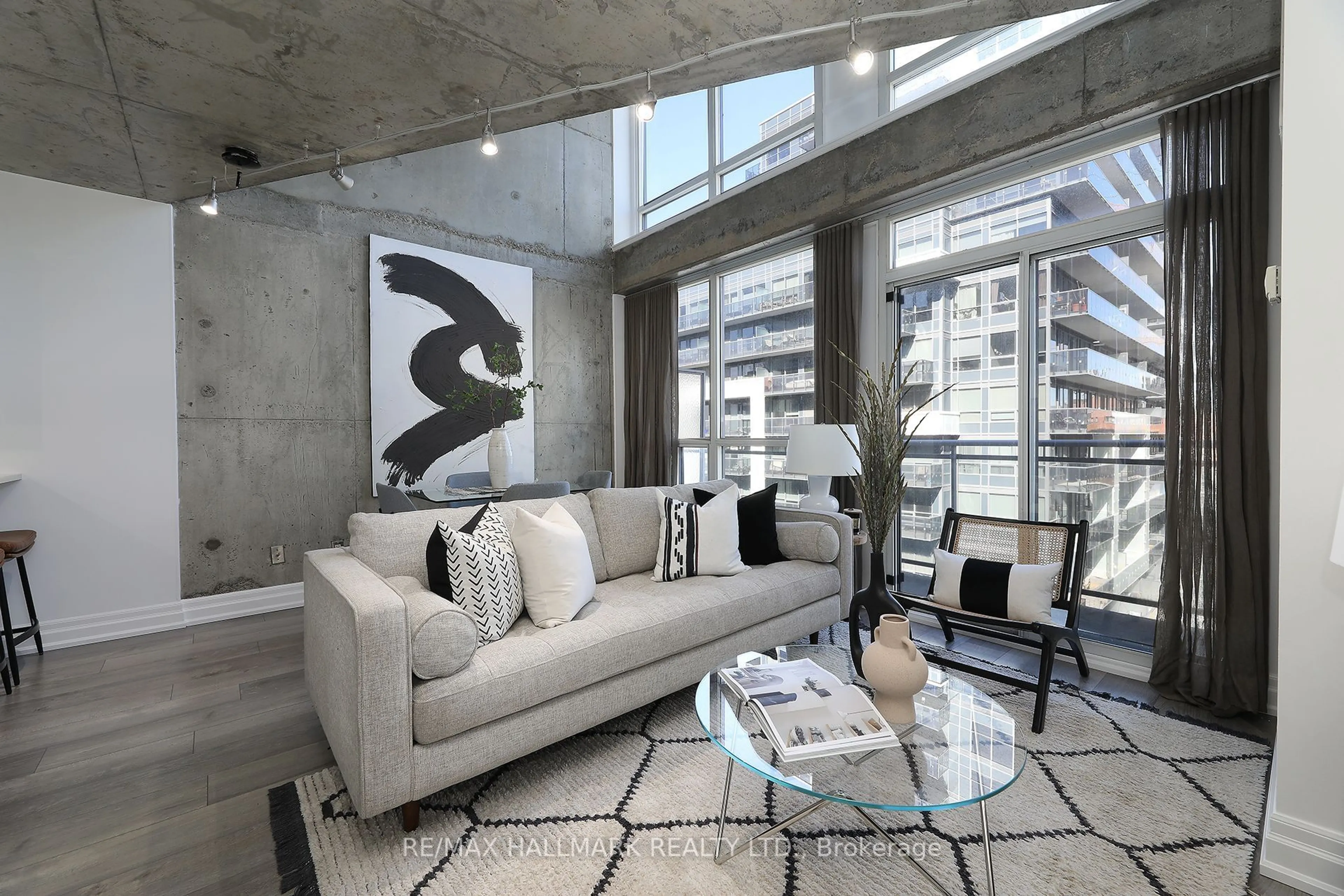 Living room with furniture, cement floor for 1029 King St #818, Toronto Ontario M6K 3M9