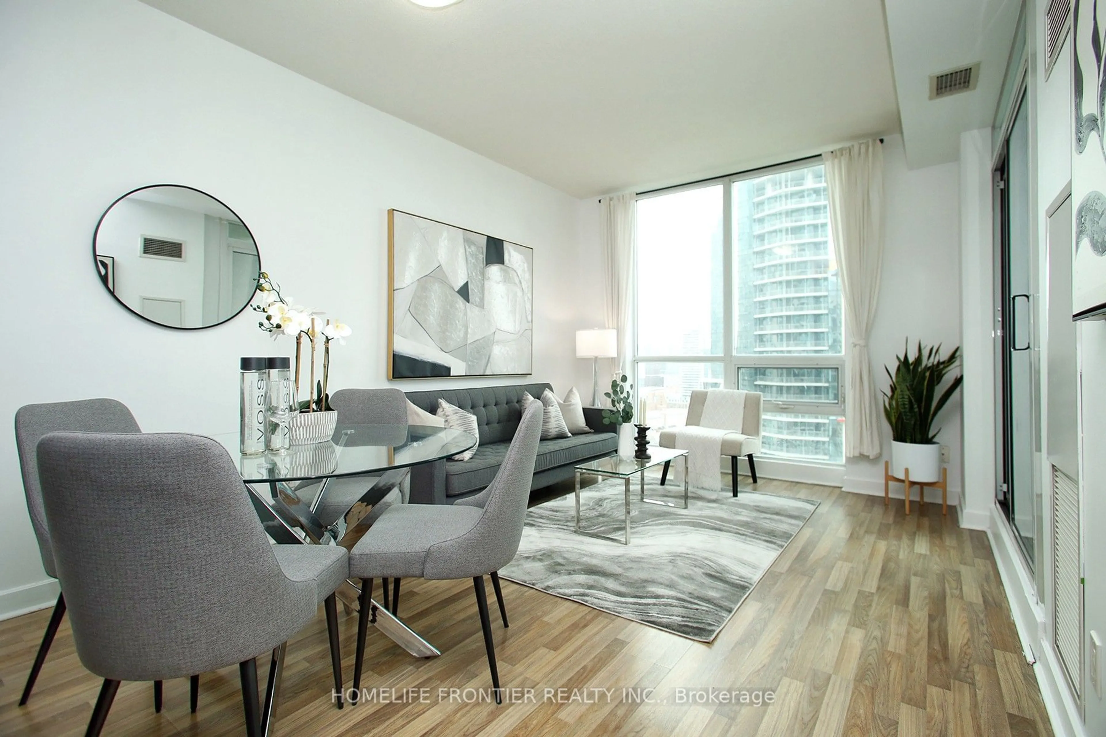 Living room with furniture, wood/laminate floor for 12 Yonge St #2403, Toronto Ontario M5E 1Z9