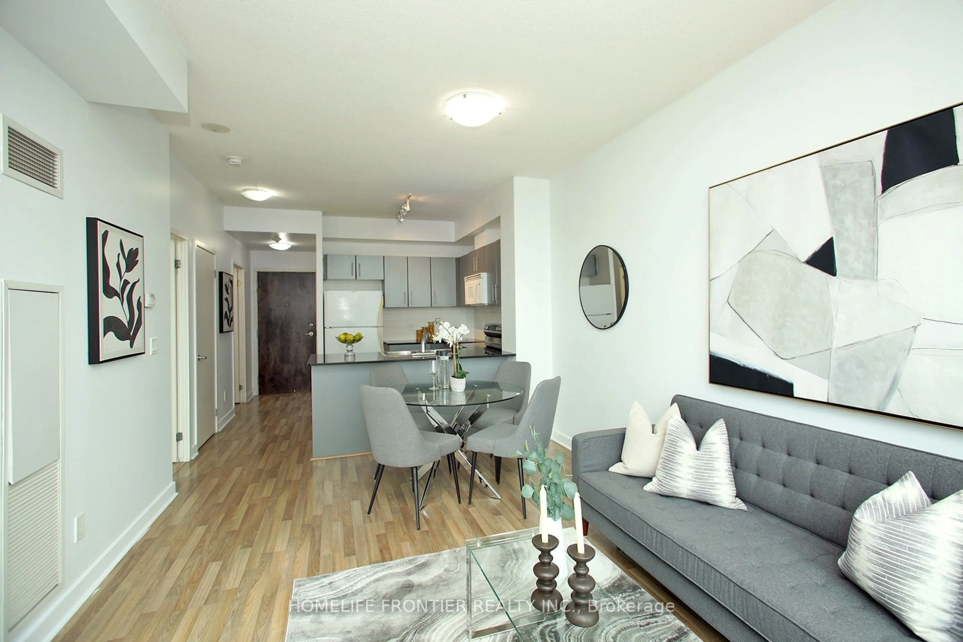 Living room with furniture, wood/laminate floor for 12 Yonge St #2403, Toronto Ontario M5E 1Z9