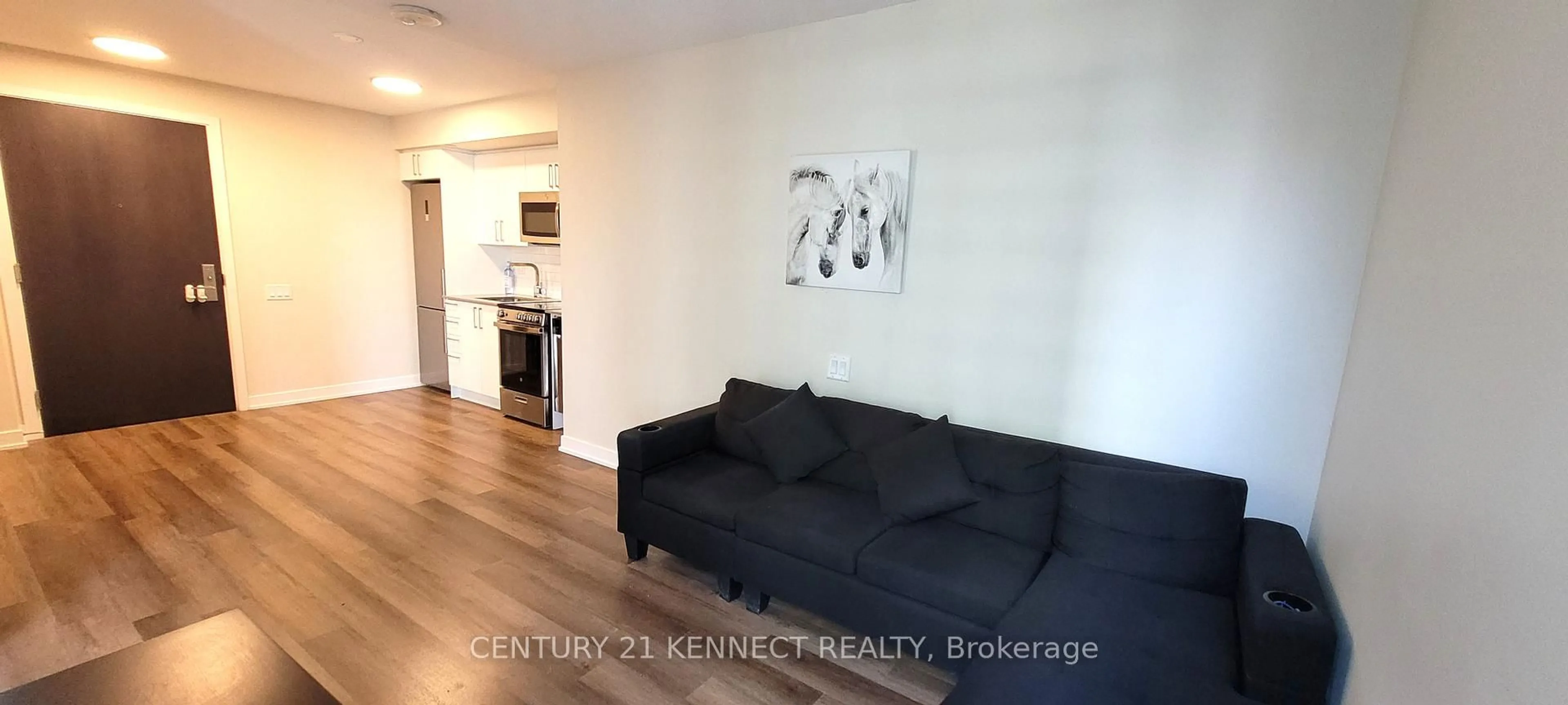 Living room with furniture, wood/laminate floor for 38 Monte Kwinter Crt #701, Toronto Ontario M3H 0E2