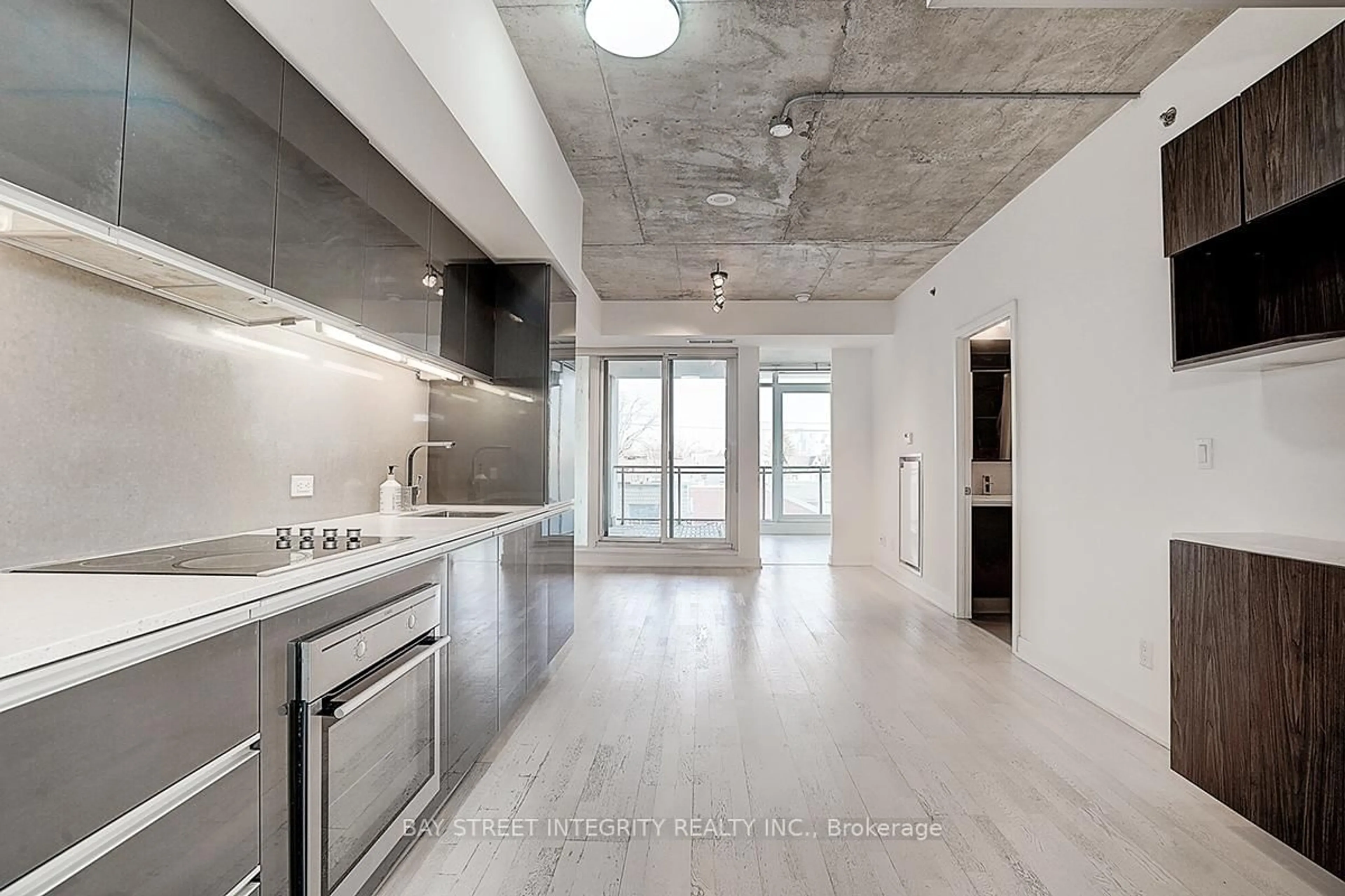 Open concept kitchen, cement floor for 20 Gladstone Ave #311, Toronto Ontario M6J 3K6