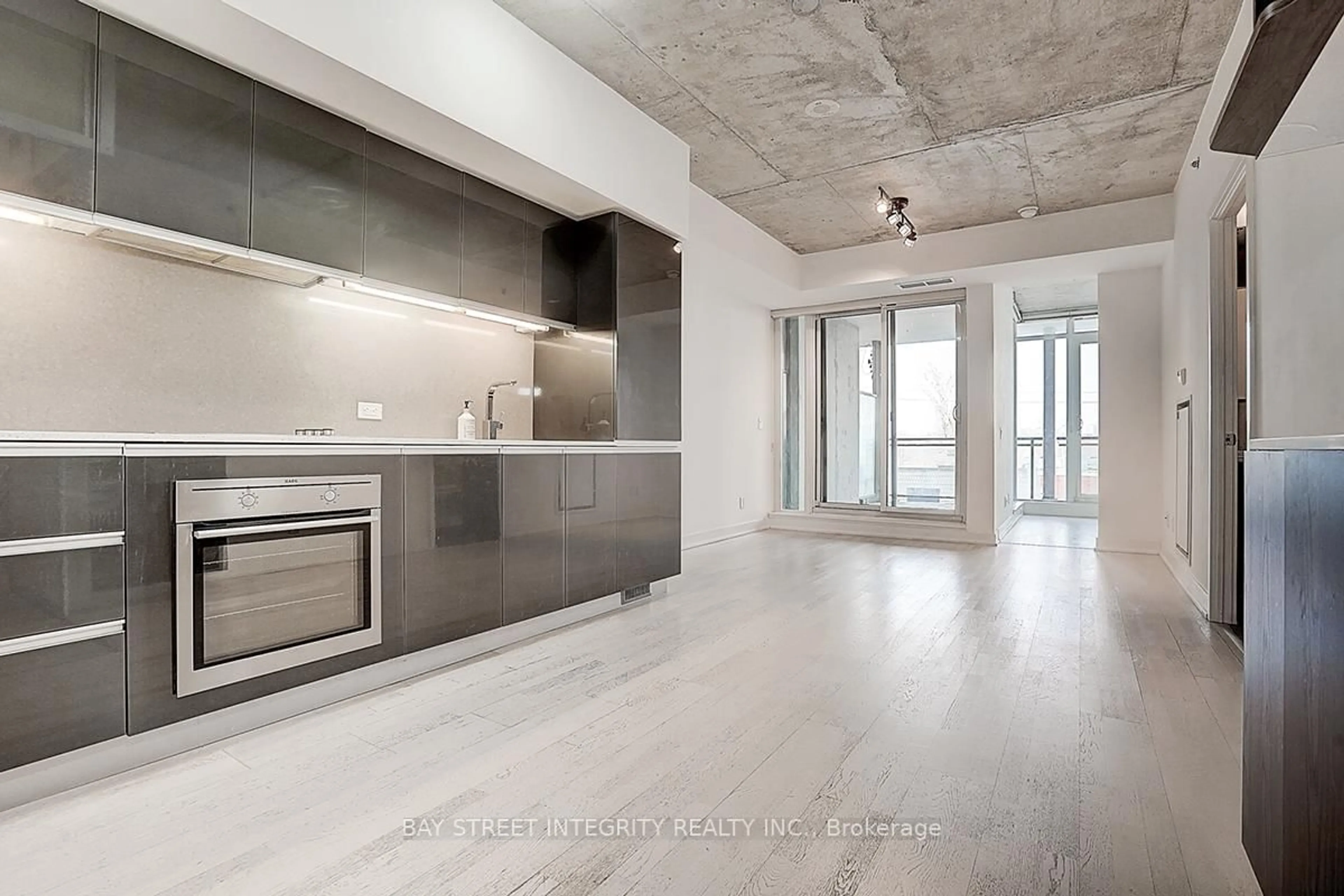 Open concept kitchen, cement floor for 20 Gladstone Ave #311, Toronto Ontario M6J 3K6