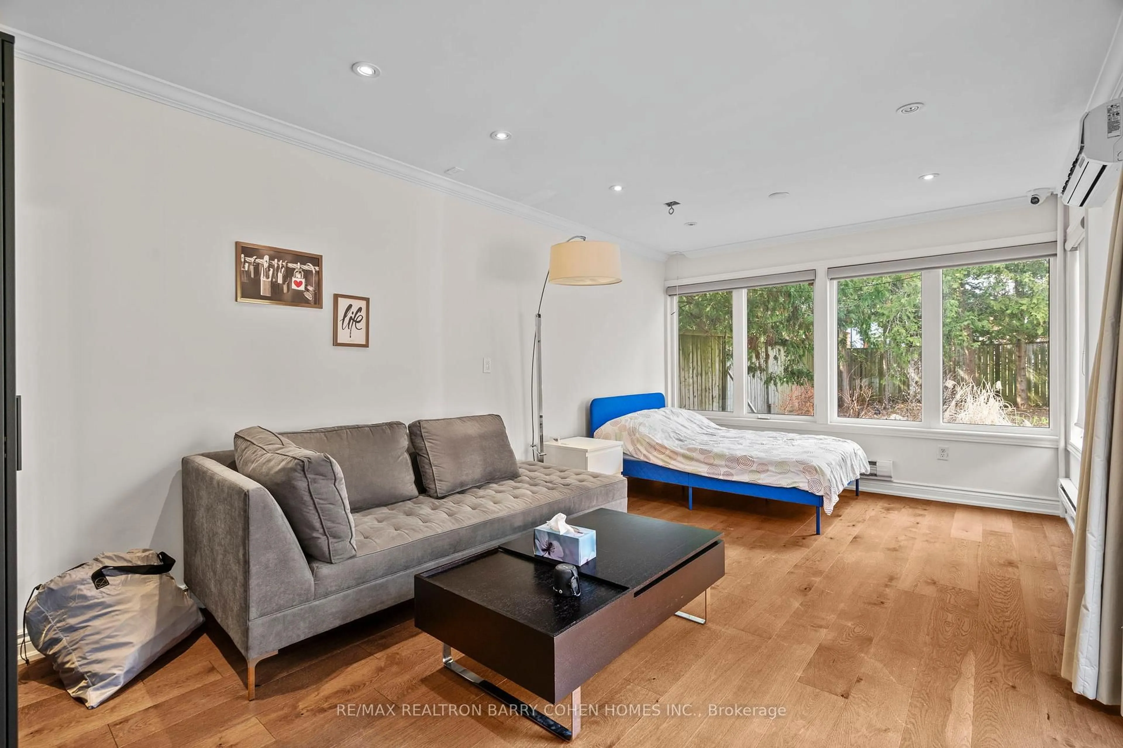 Living room with furniture, wood/laminate floor for 32 Beechwood Ave, Toronto Ontario M6N 4T1