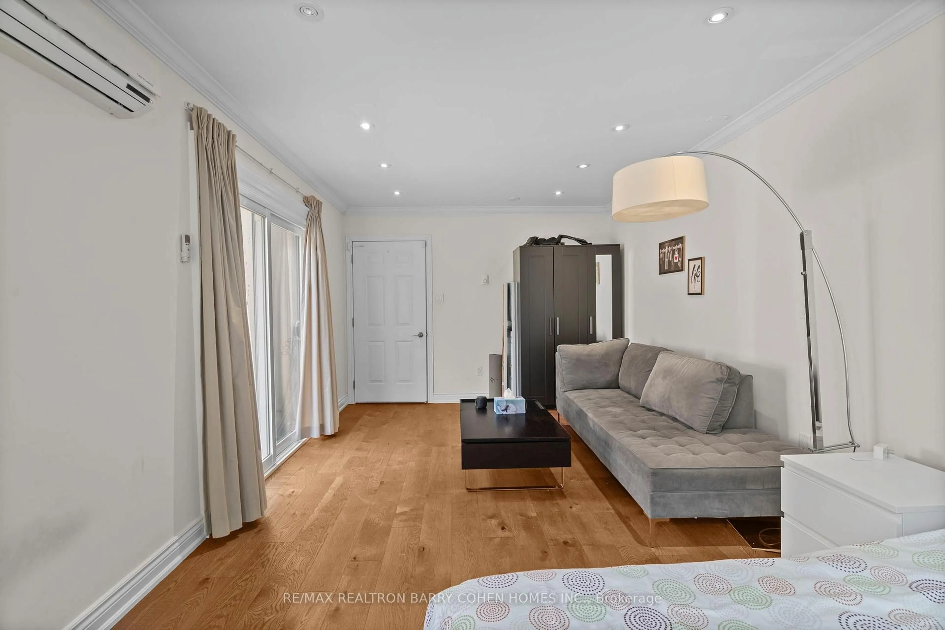 Living room with furniture, wood/laminate floor for 32 Beechwood Ave, Toronto Ontario M6N 4T1