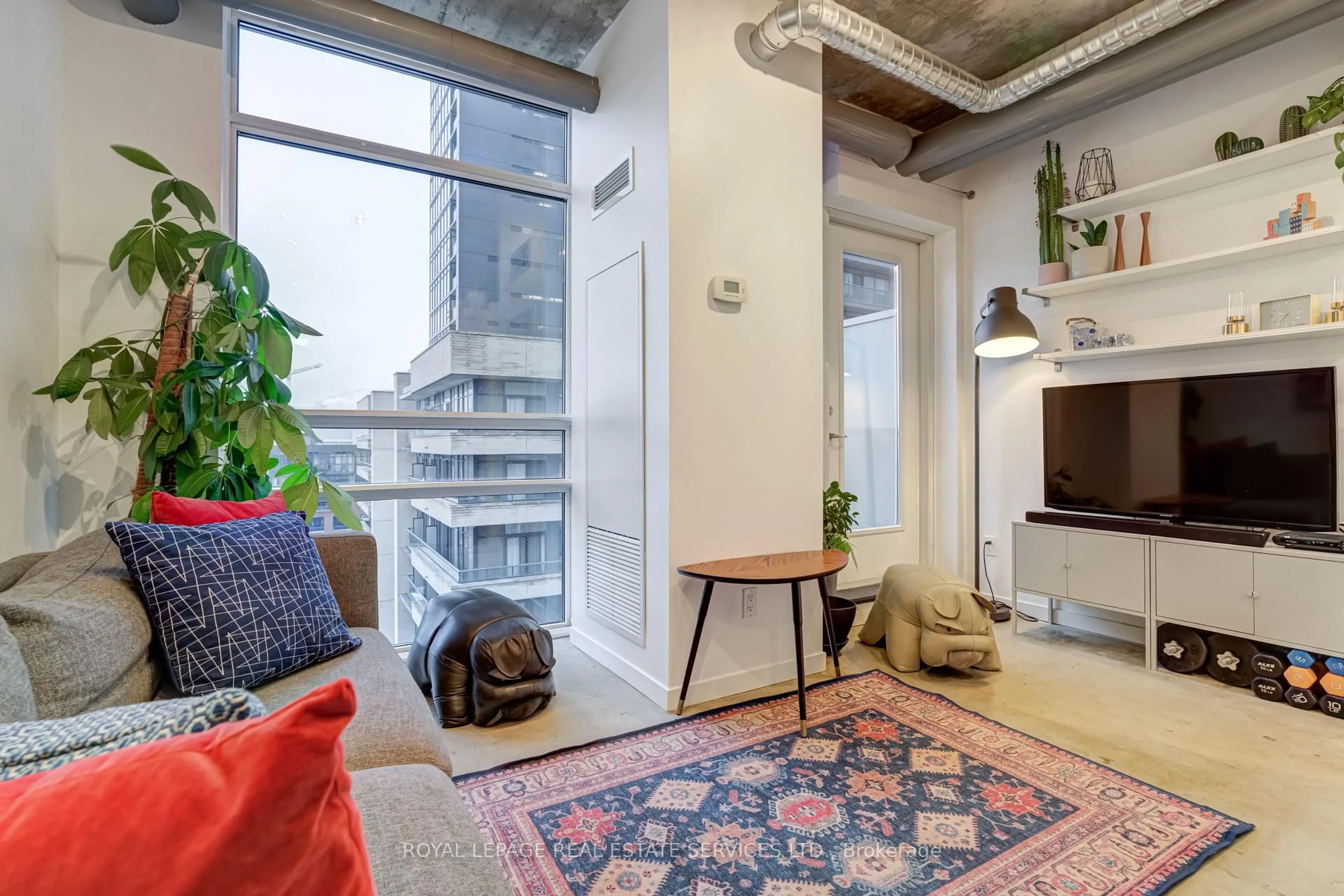 Living room with furniture, cement floor for 150 Sudbury St #711, Toronto Ontario M6J 3S8