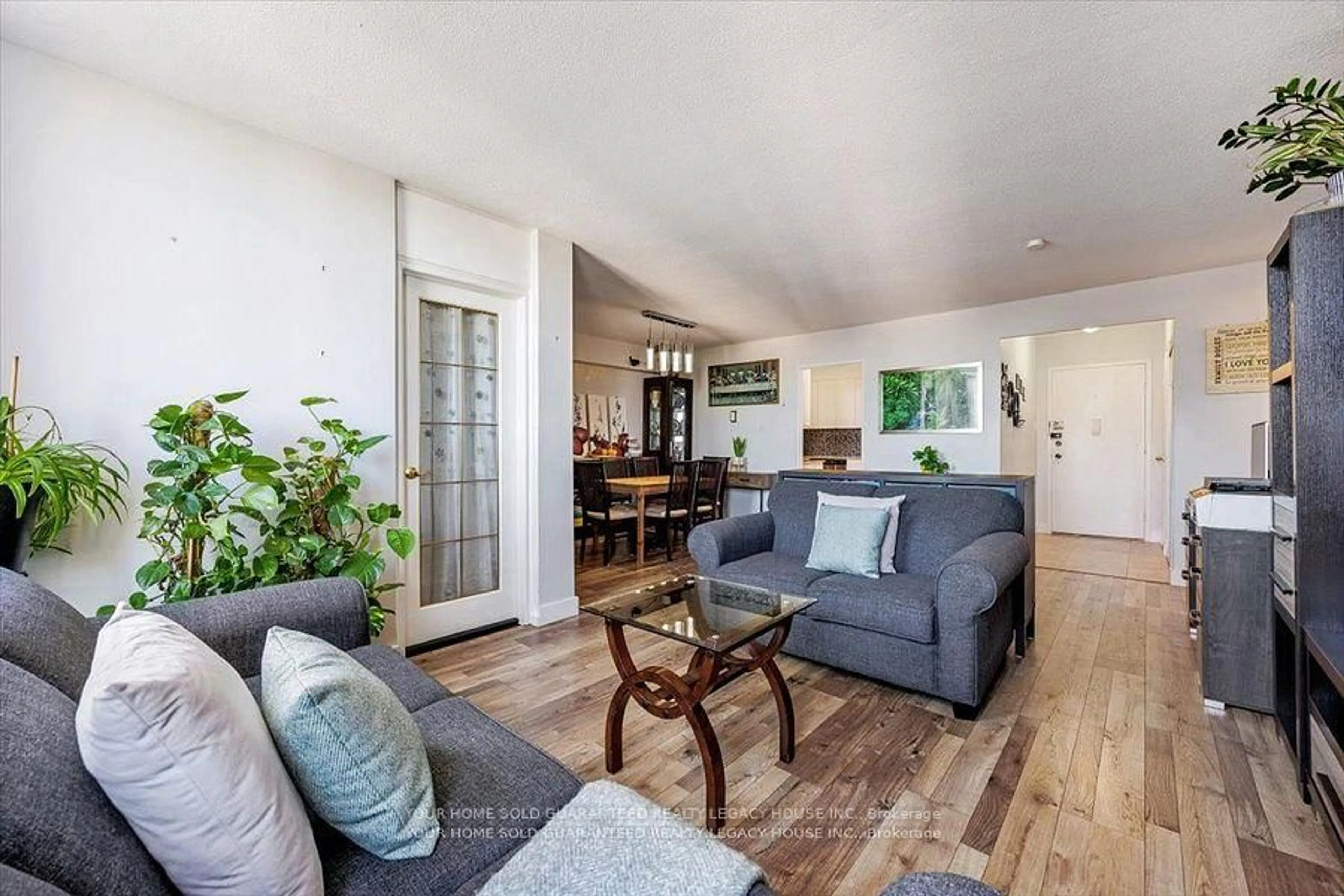 Living room with furniture, wood/laminate floor for 130 Neptune Dr #607, Toronto Ontario M6A 1X5