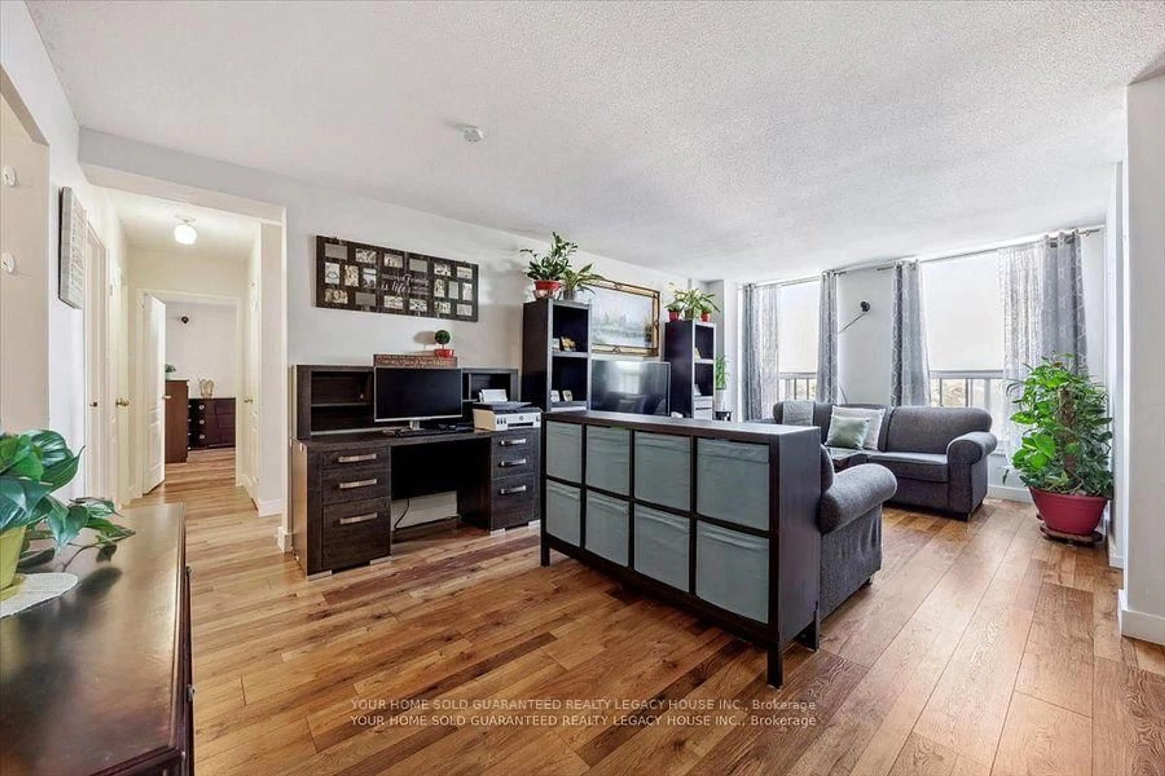 Living room with furniture, wood/laminate floor for 130 Neptune Dr #607, Toronto Ontario M6A 1X5