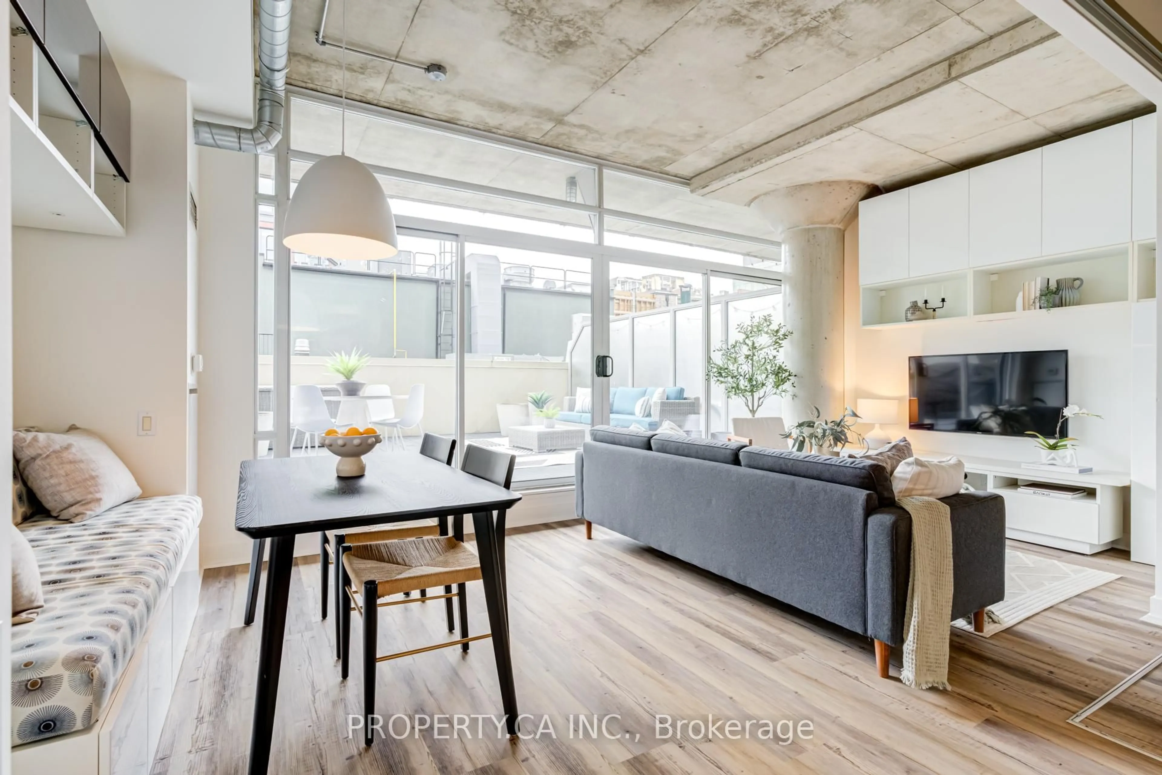 Living room with furniture, cement floor for 66 Portland St #210, Toronto Ontario M5V 2M6
