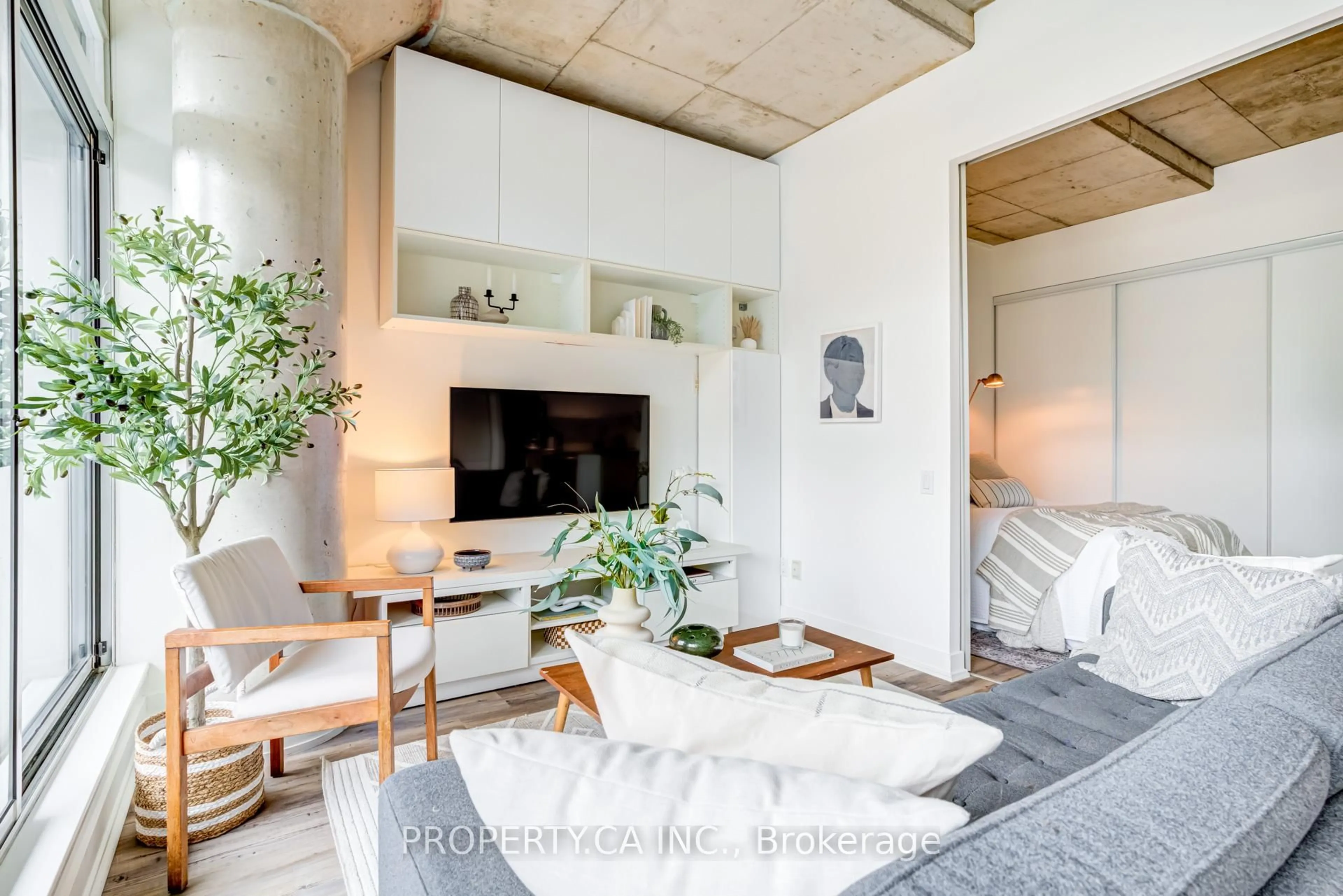 Living room with furniture, cement floor for 66 Portland St #210, Toronto Ontario M5V 2M6