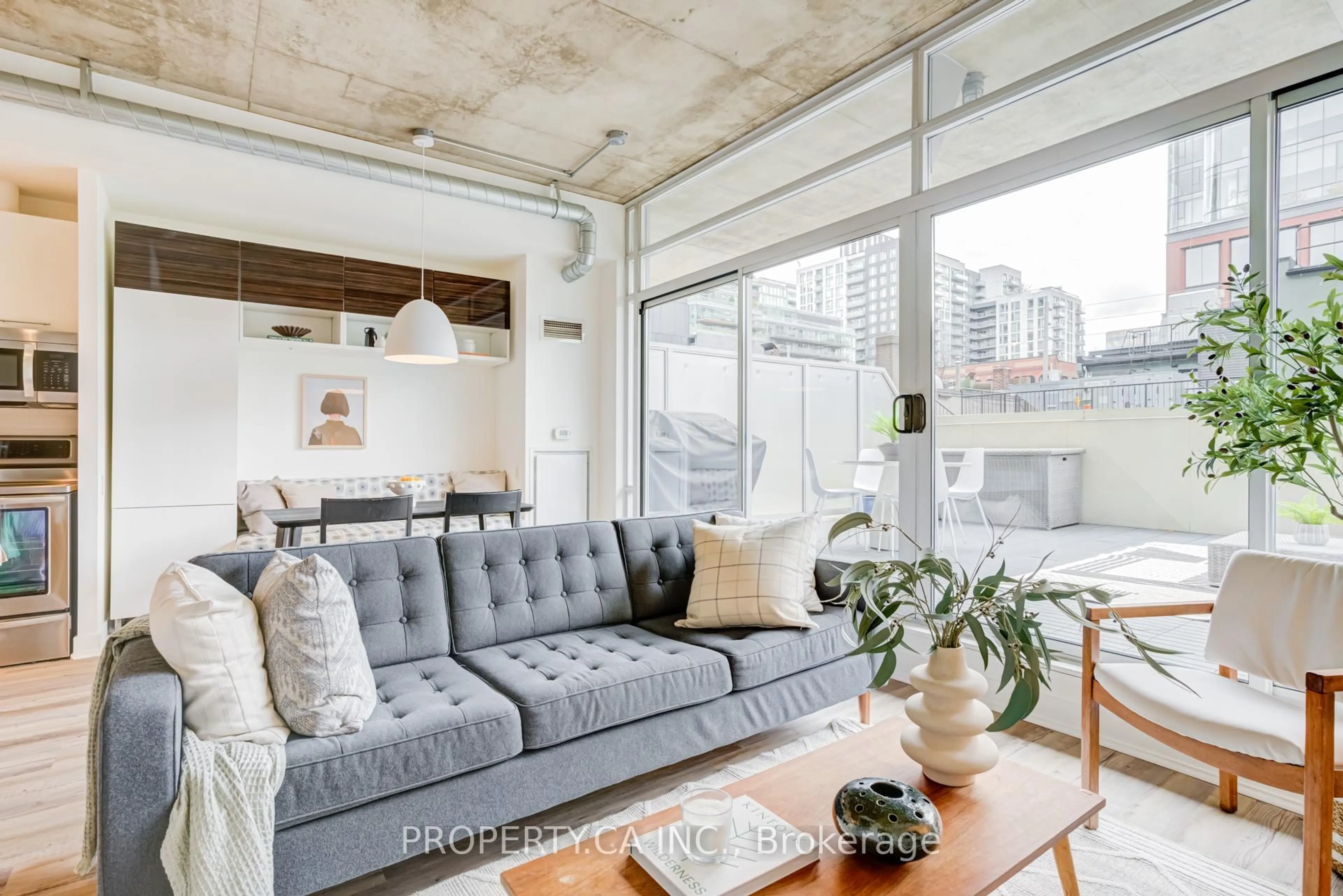 Living room with furniture, cement floor for 66 Portland St #210, Toronto Ontario M5V 2M6