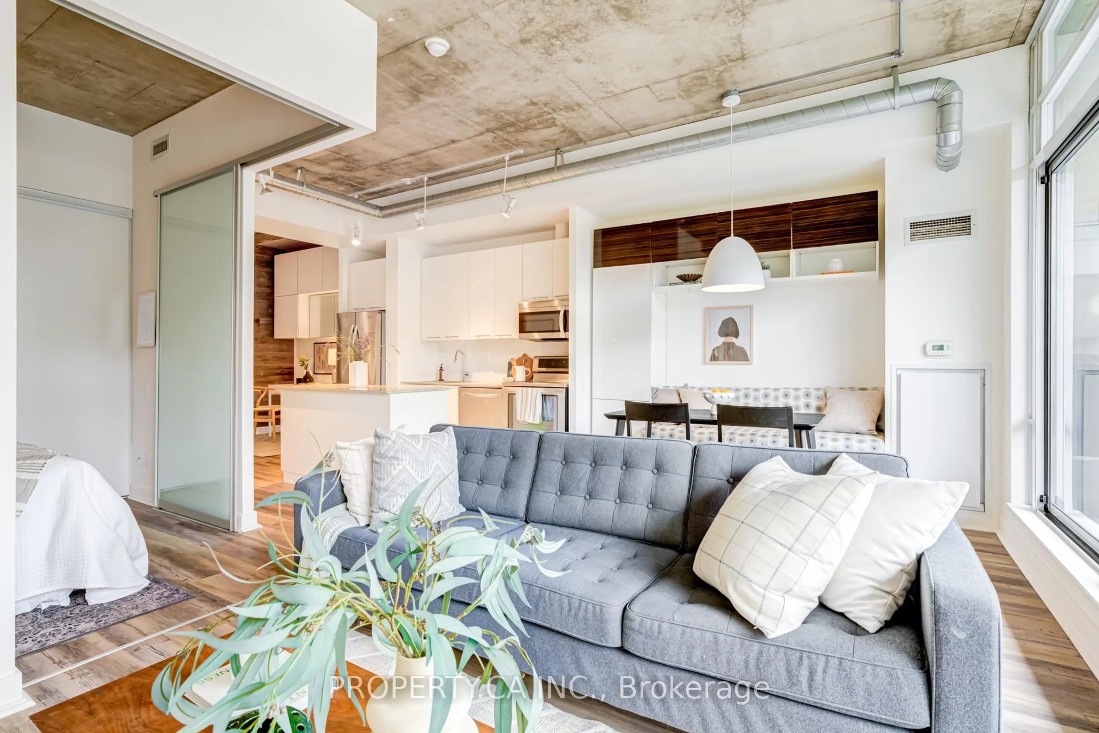 Living room with furniture, cement floor for 66 Portland St #210, Toronto Ontario M5V 2M6