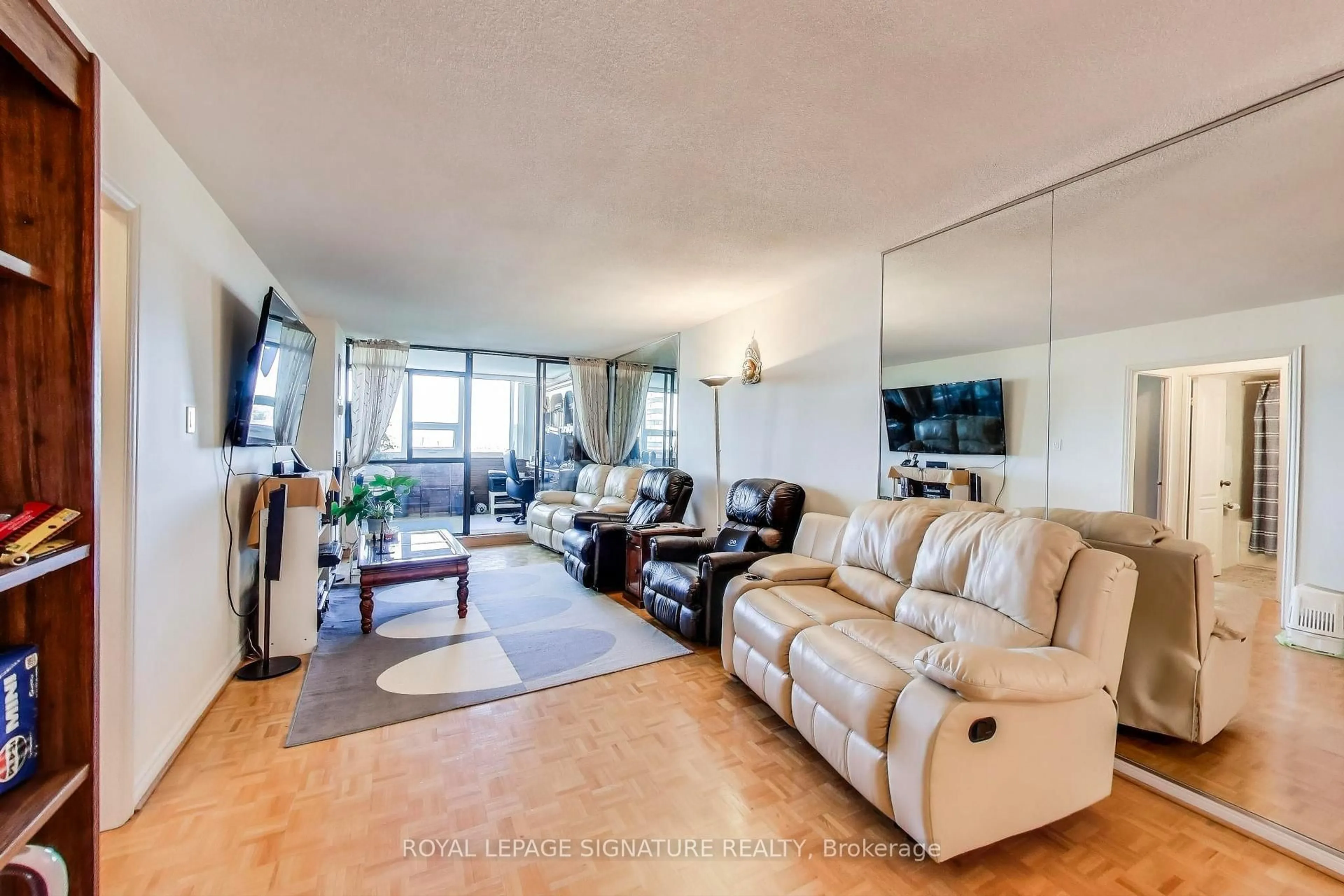 Living room with furniture, wood/laminate floor for 3303 Don Mills Rd #1205, Toronto Ontario M2J 4T6