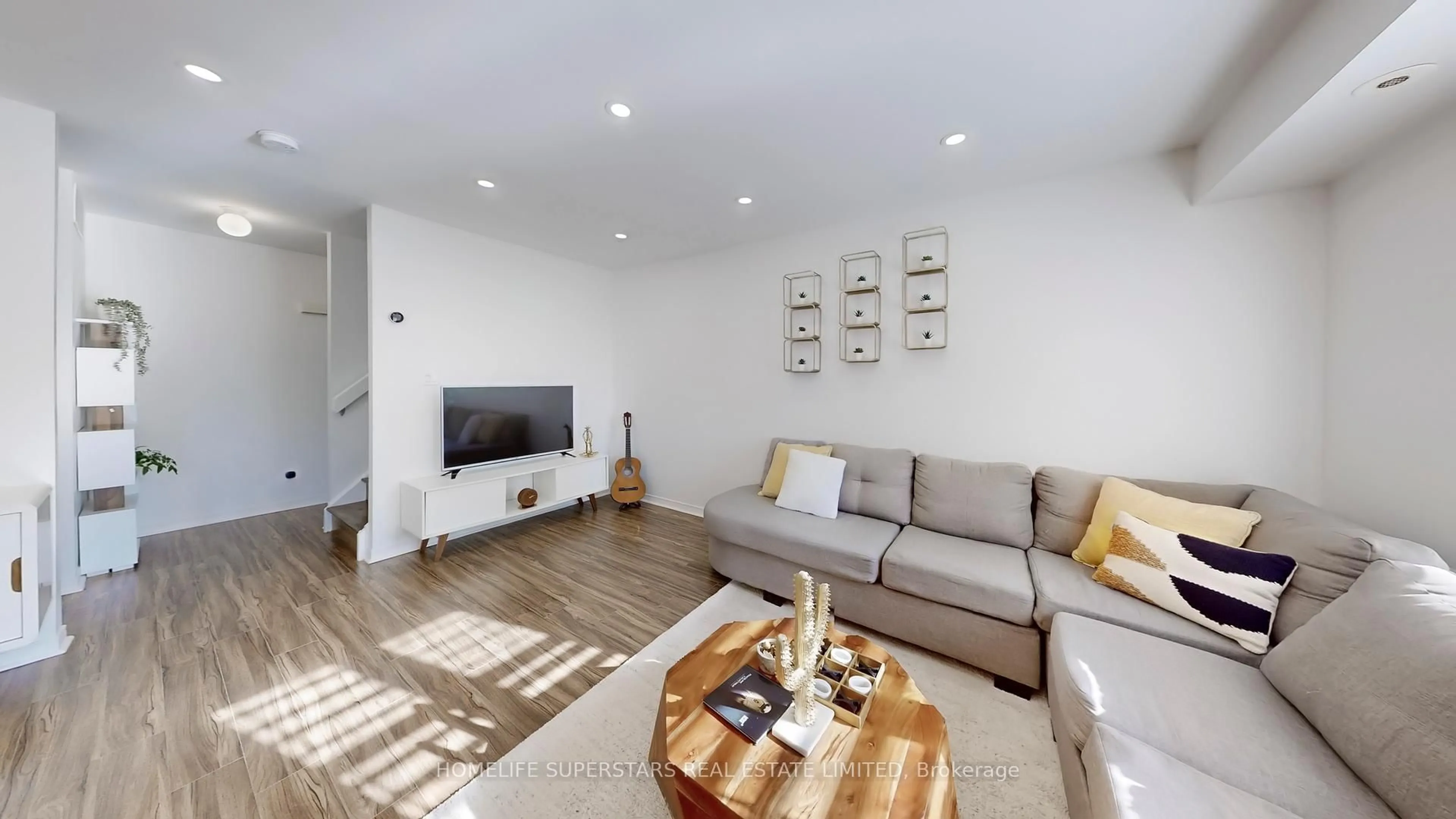 Living room with furniture, wood/laminate floor for 21 Pirandello St #1234, Toronto Ontario M6K 3P4