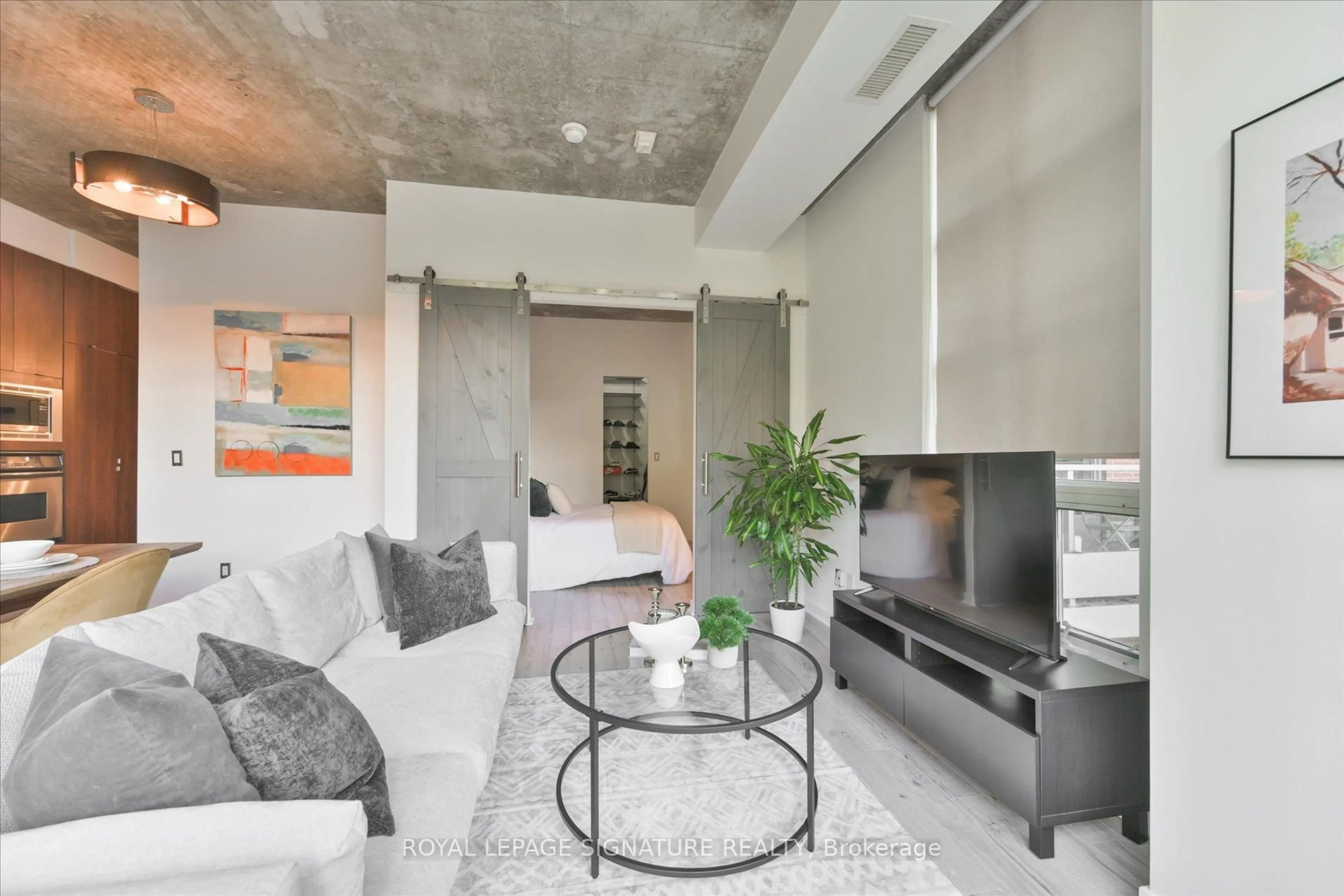 Living room with furniture, cement floor for 23 Brant St #305, Toronto Ontario M5V 2L5