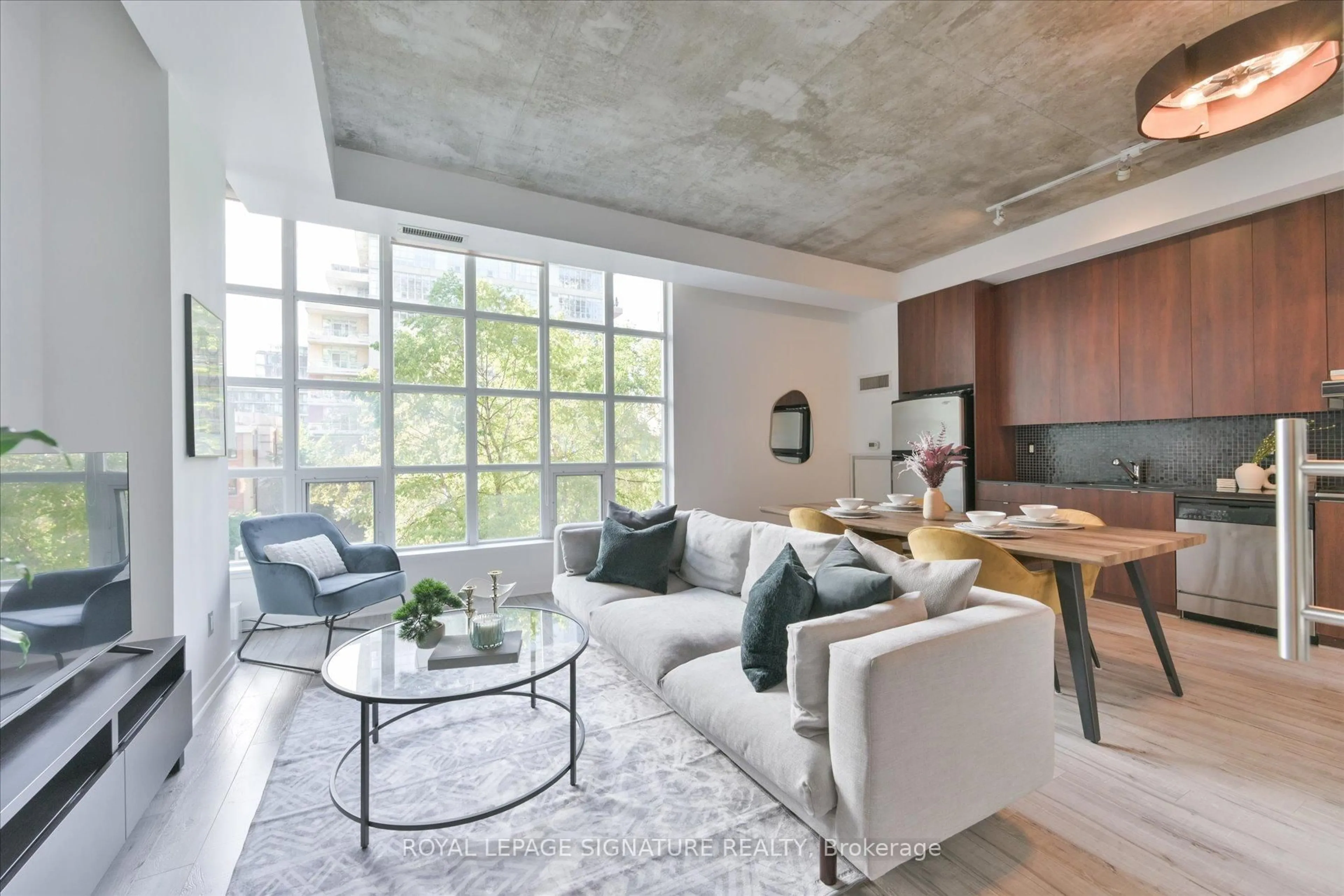Living room with furniture, cement floor for 23 Brant St #305, Toronto Ontario M5V 2L5