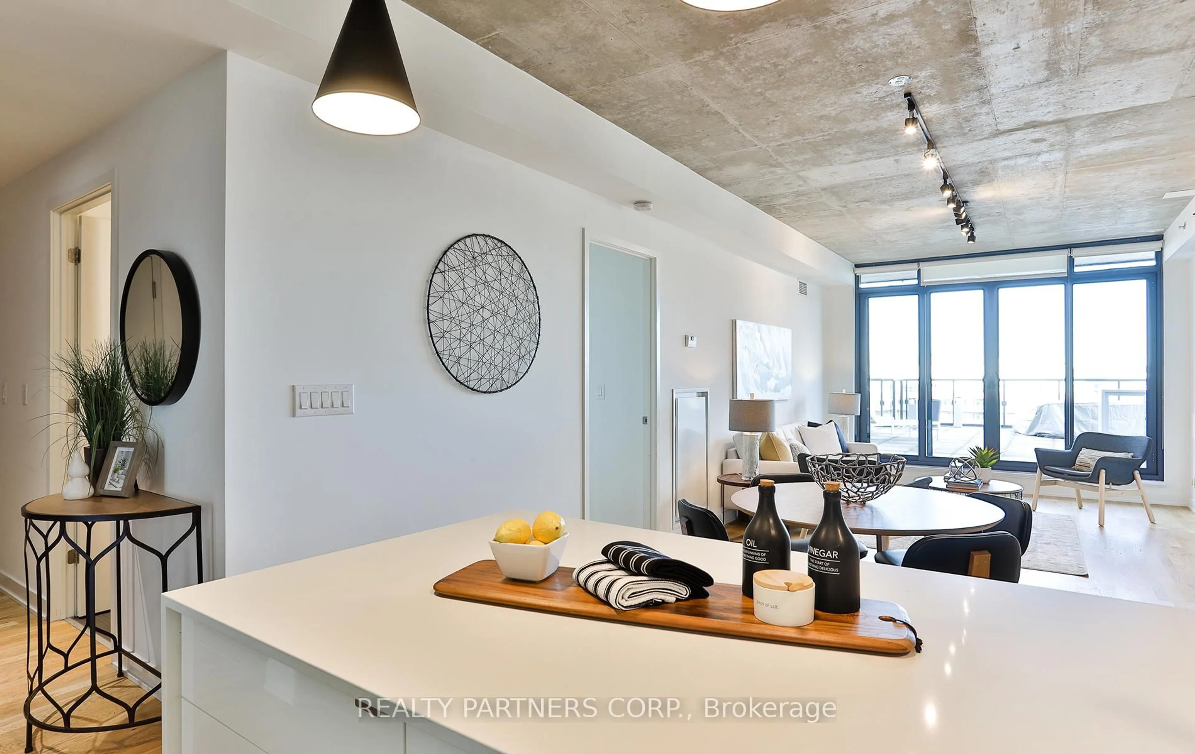 Open concept kitchen, cement floor for 8 Dovercourt Ave #910, Toronto Ontario M6J 0B6