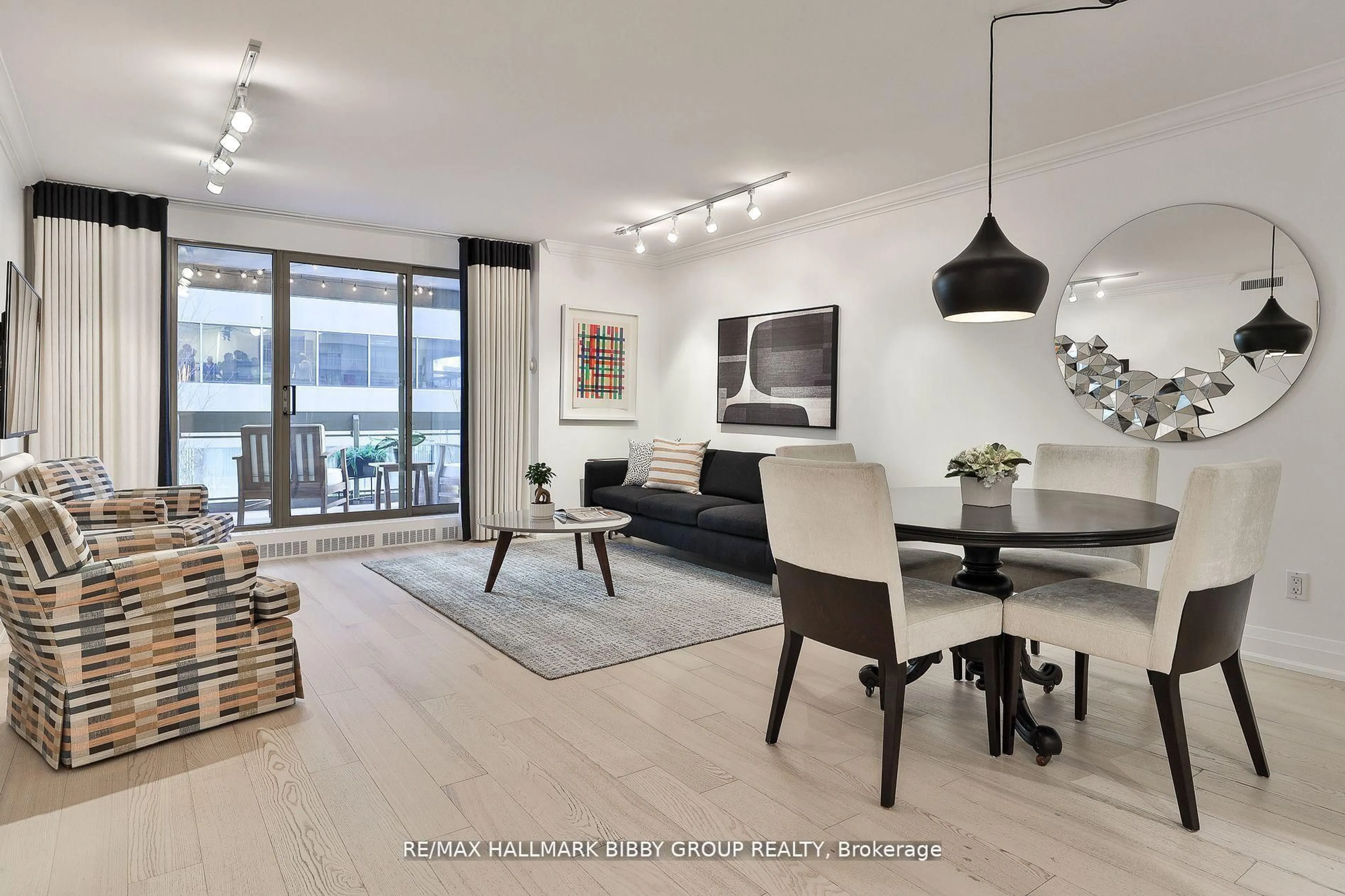 Living room with furniture, wood/laminate floor for 61 St Clair Ave #206, Toronto Ontario M4V 2Y8