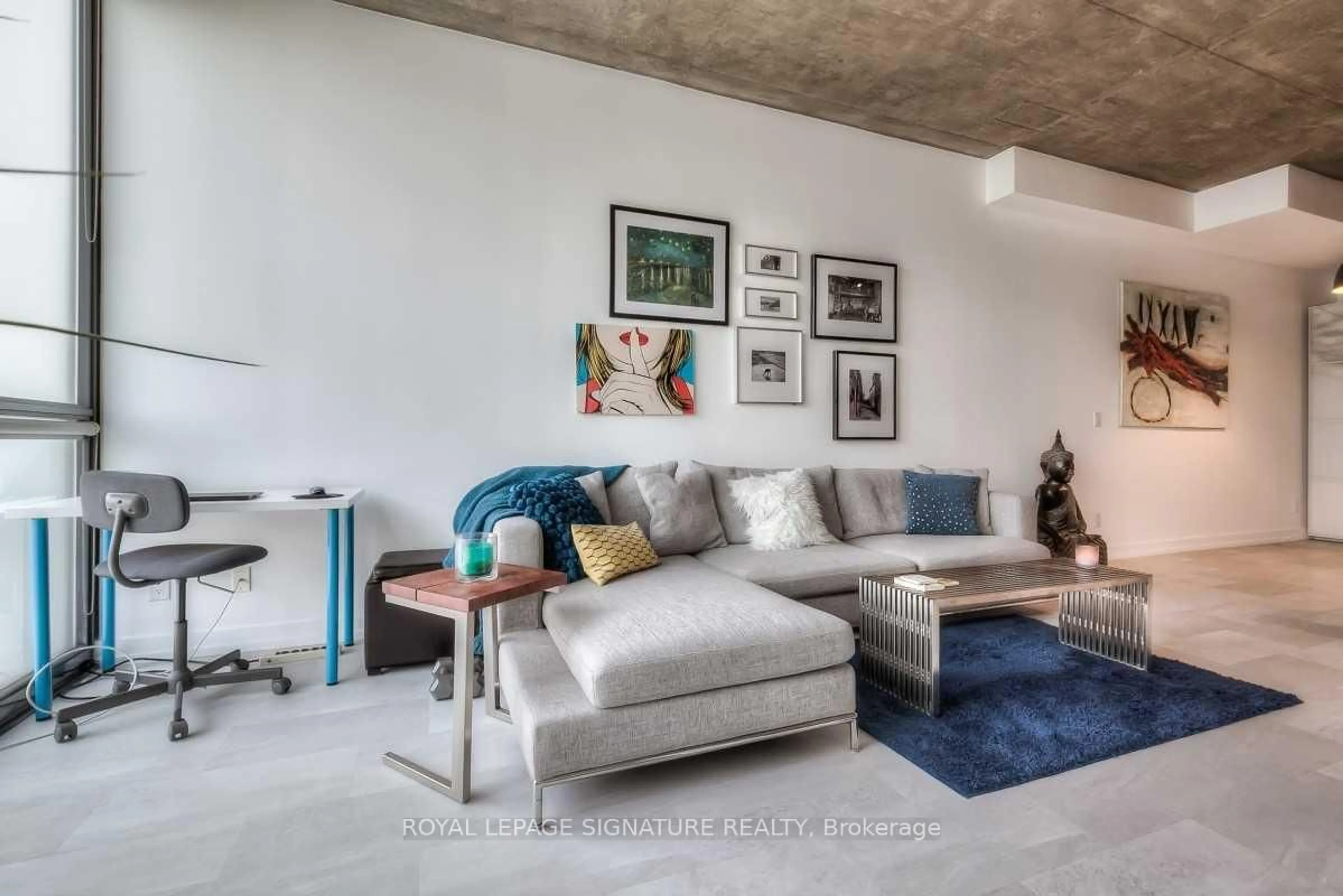 Living room with furniture, cement floor for 60 Bathurst St #909, Toronto Ontario M5V 2P4