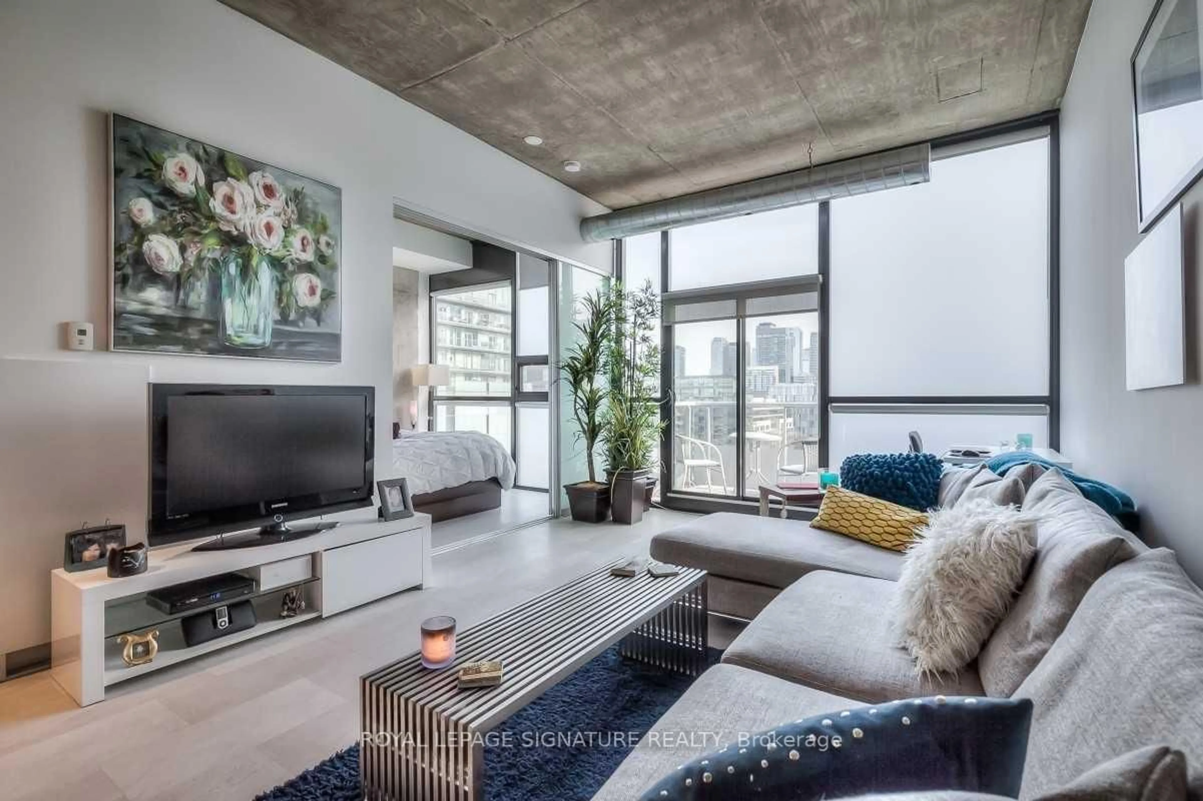 Living room with furniture, cement floor for 60 Bathurst St #909, Toronto Ontario M5V 2P4