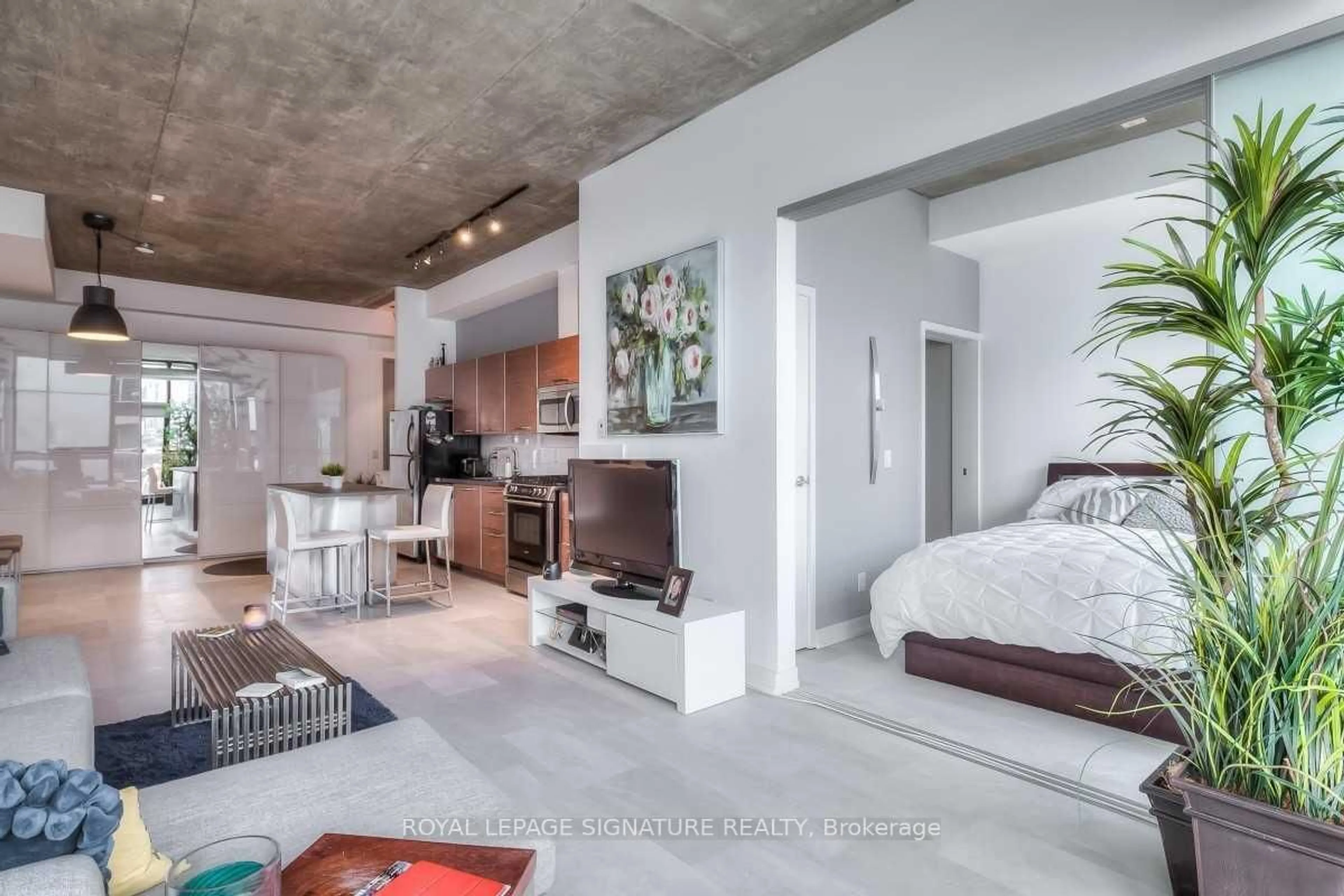 Living room with furniture, cement floor for 60 Bathurst St #909, Toronto Ontario M5V 2P4