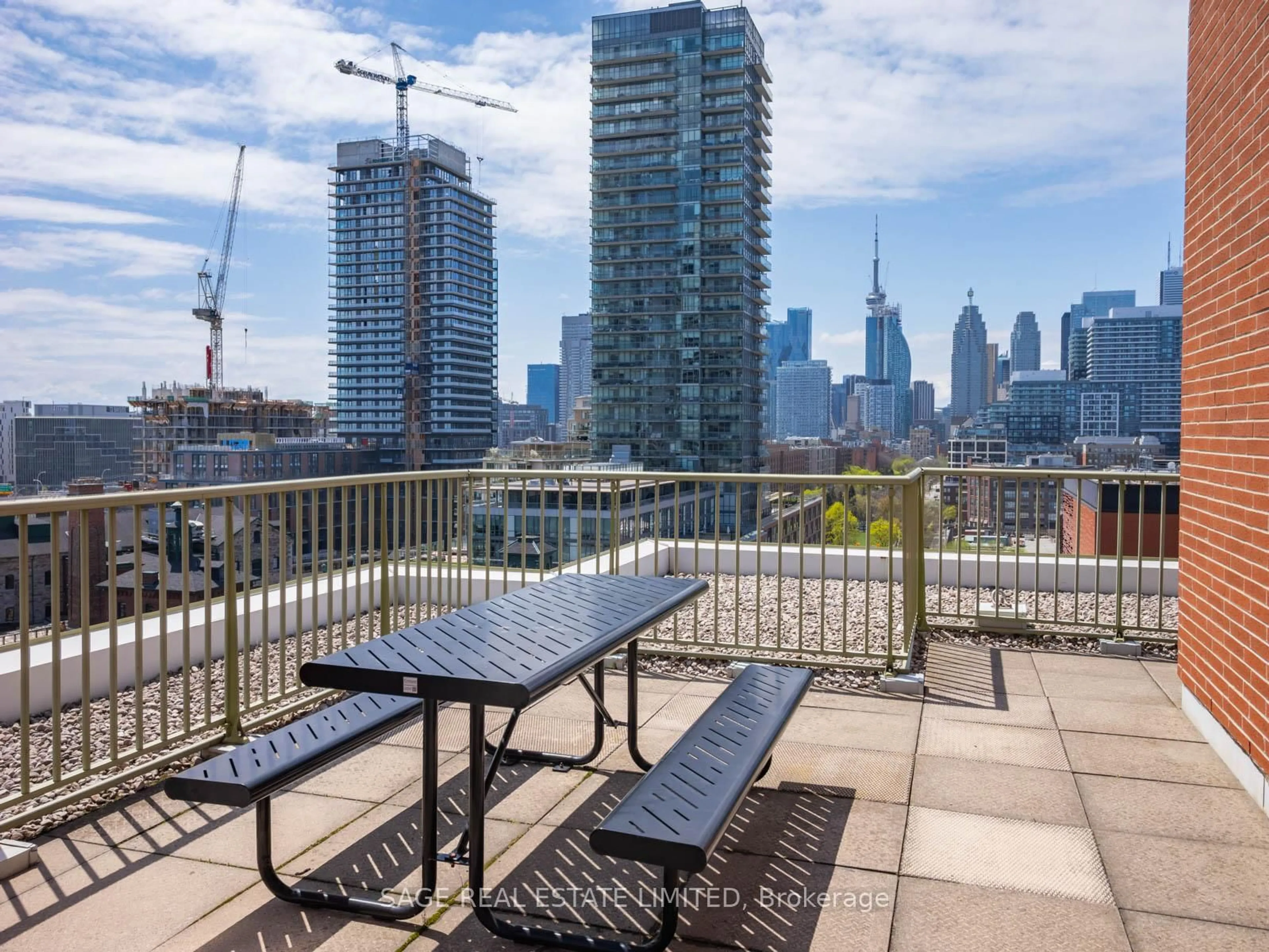 Patio, city buildings view from balcony for 70 Mill St #909, Toronto Ontario M5A 4R1