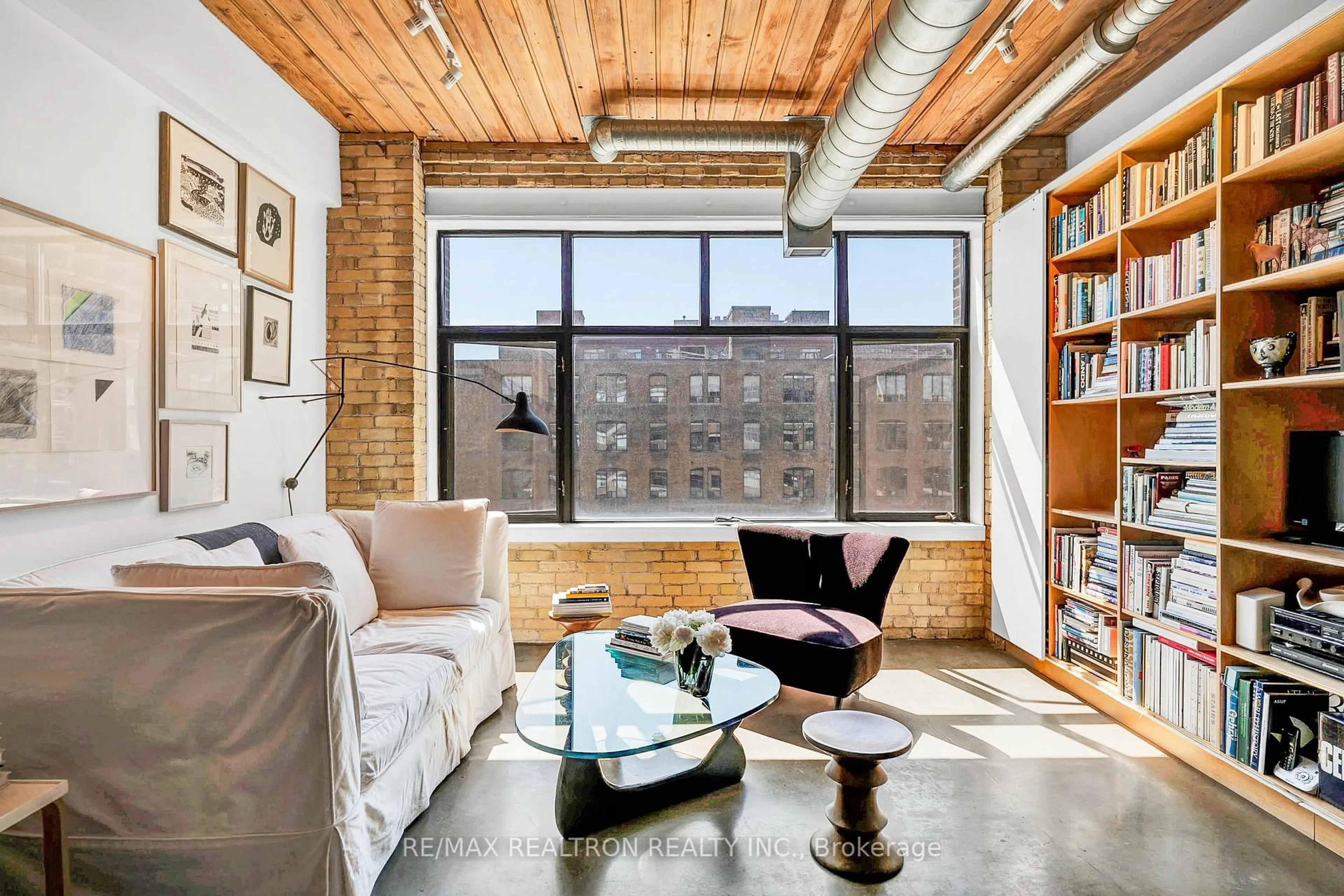 Living room with furniture, cement floor for 436 Wellington St #403, Toronto Ontario M5V 1E3