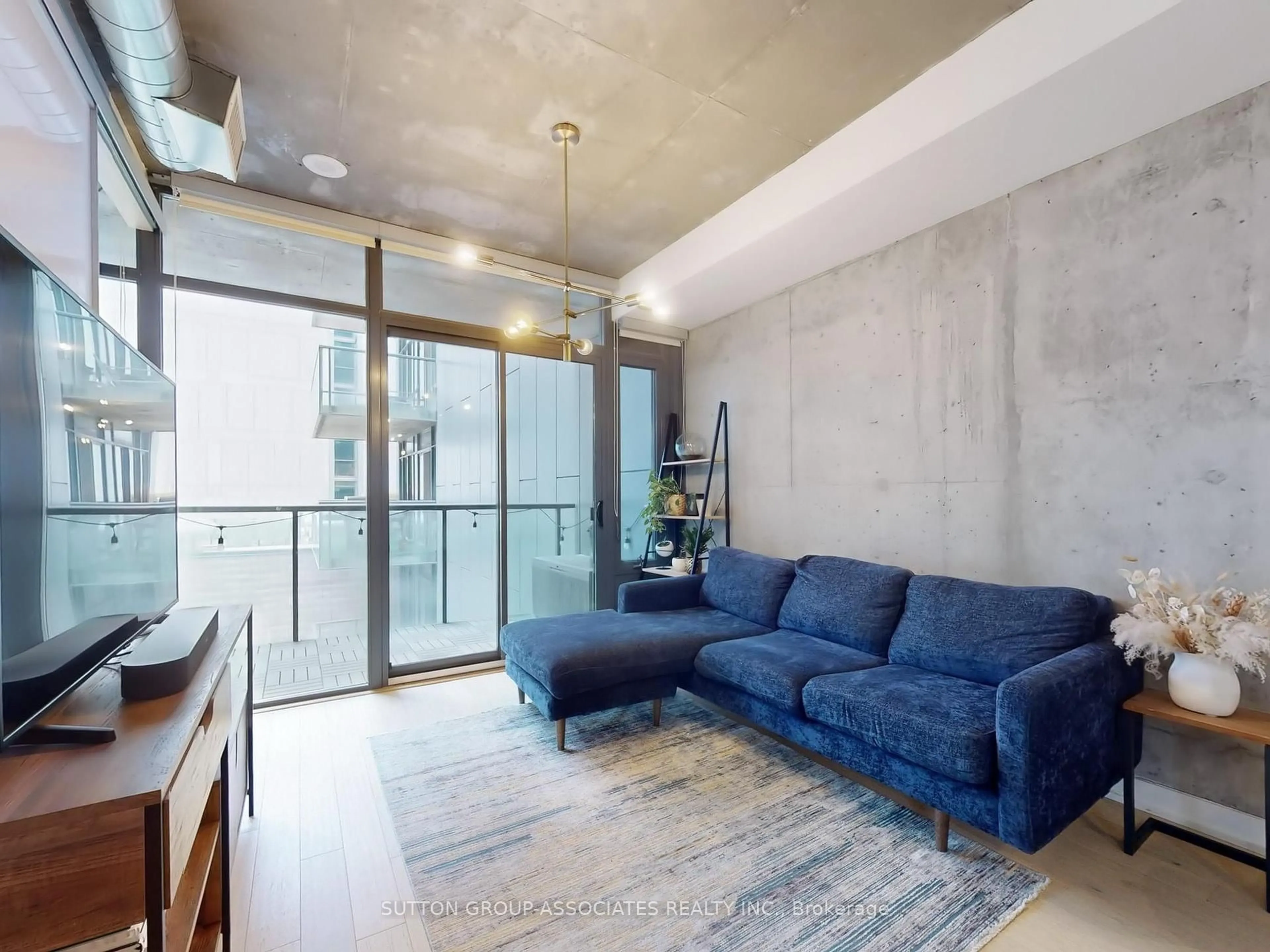 Living room with furniture, cement floor for 138 Princess St #811, Toronto Ontario M5A 0B1