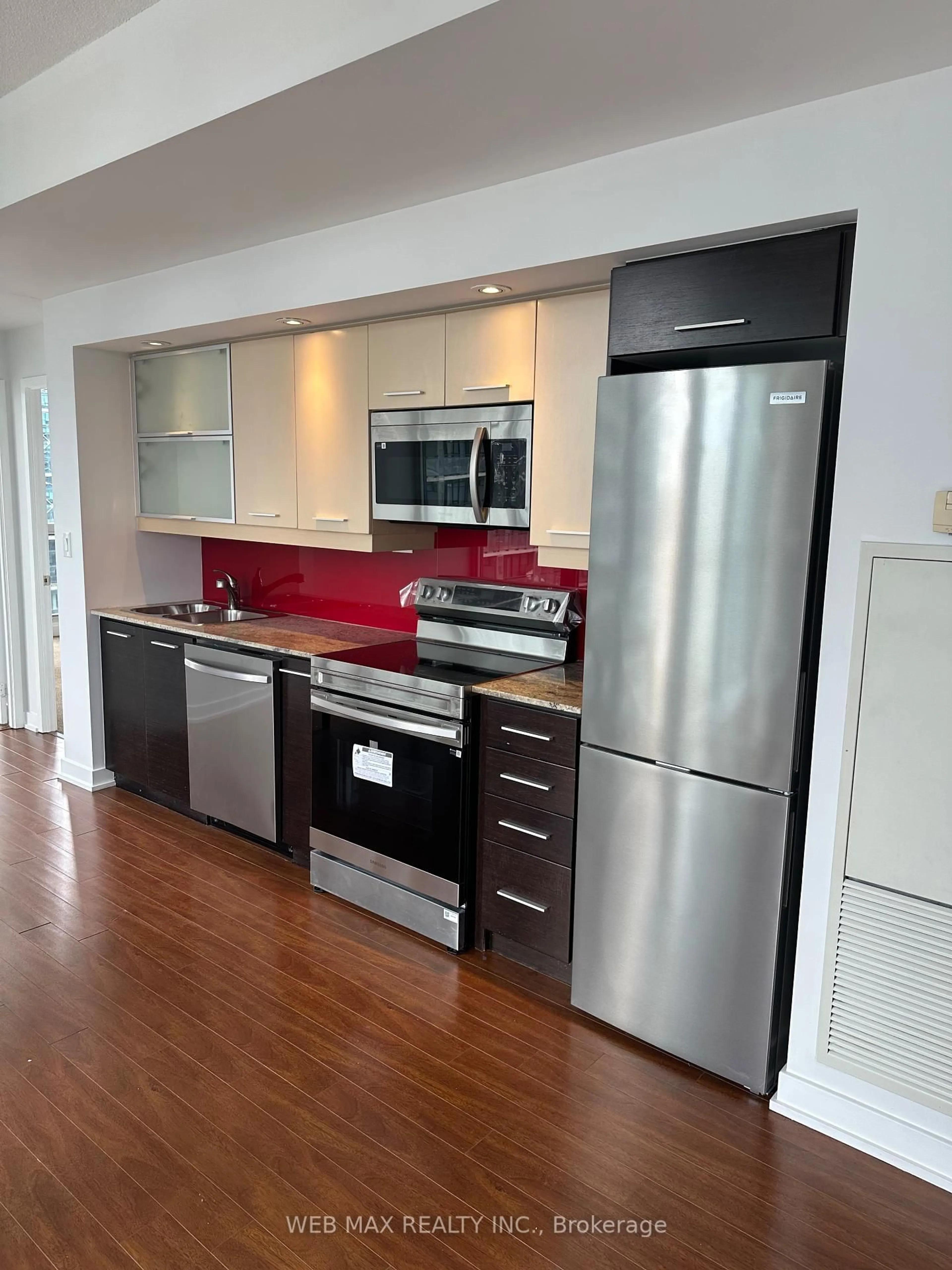 Open concept kitchen, wood/laminate floor for 8 Telegram Mews #2009, Toronto Ontario M5V 3Z5