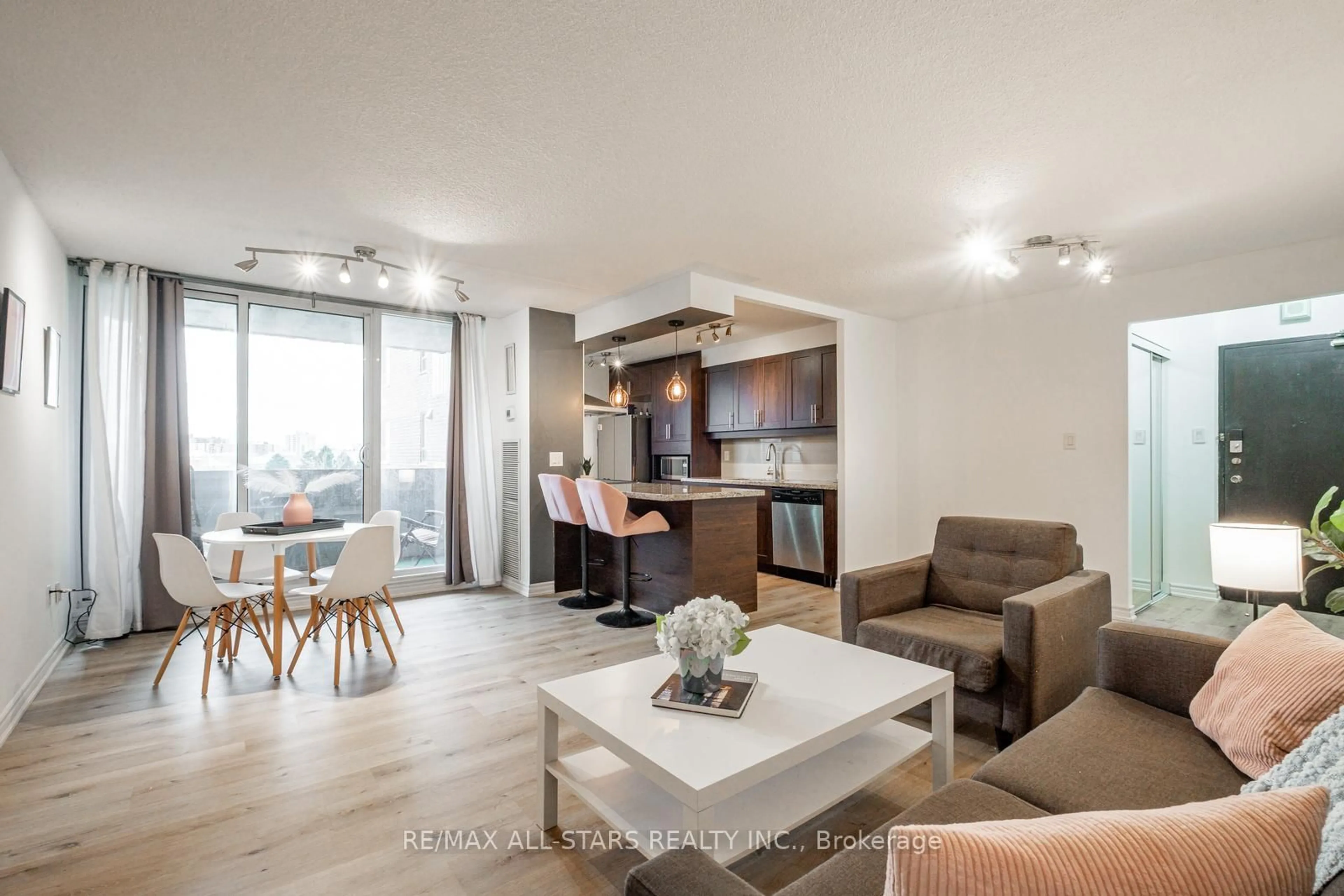Living room with furniture, wood/laminate floor for 10 Muirhead Rd #610, Toronto Ontario M2J 4P9