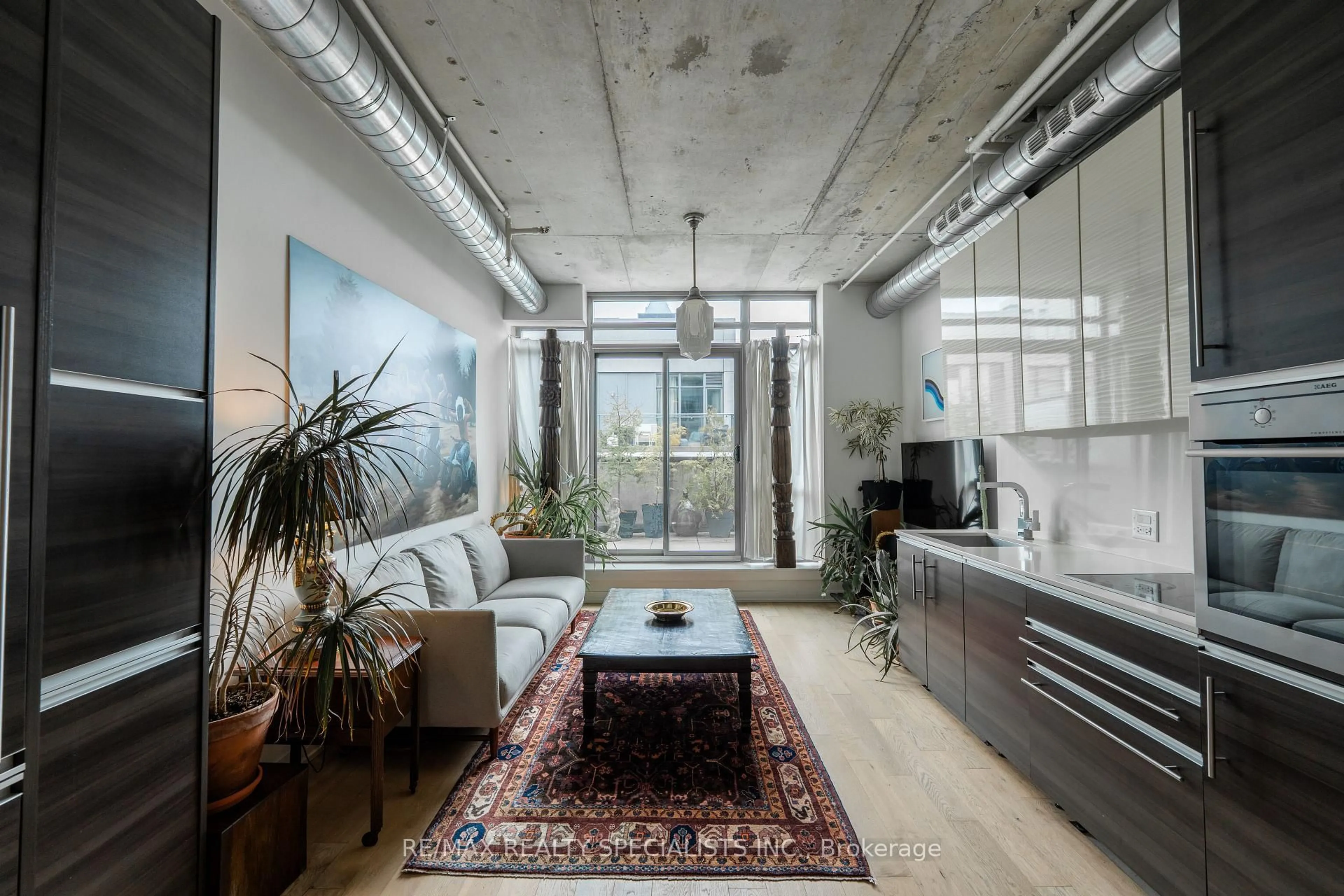Living room with furniture, cement floor for 8 Gladstone Ave #PH 705, Toronto Ontario M6J 0B3